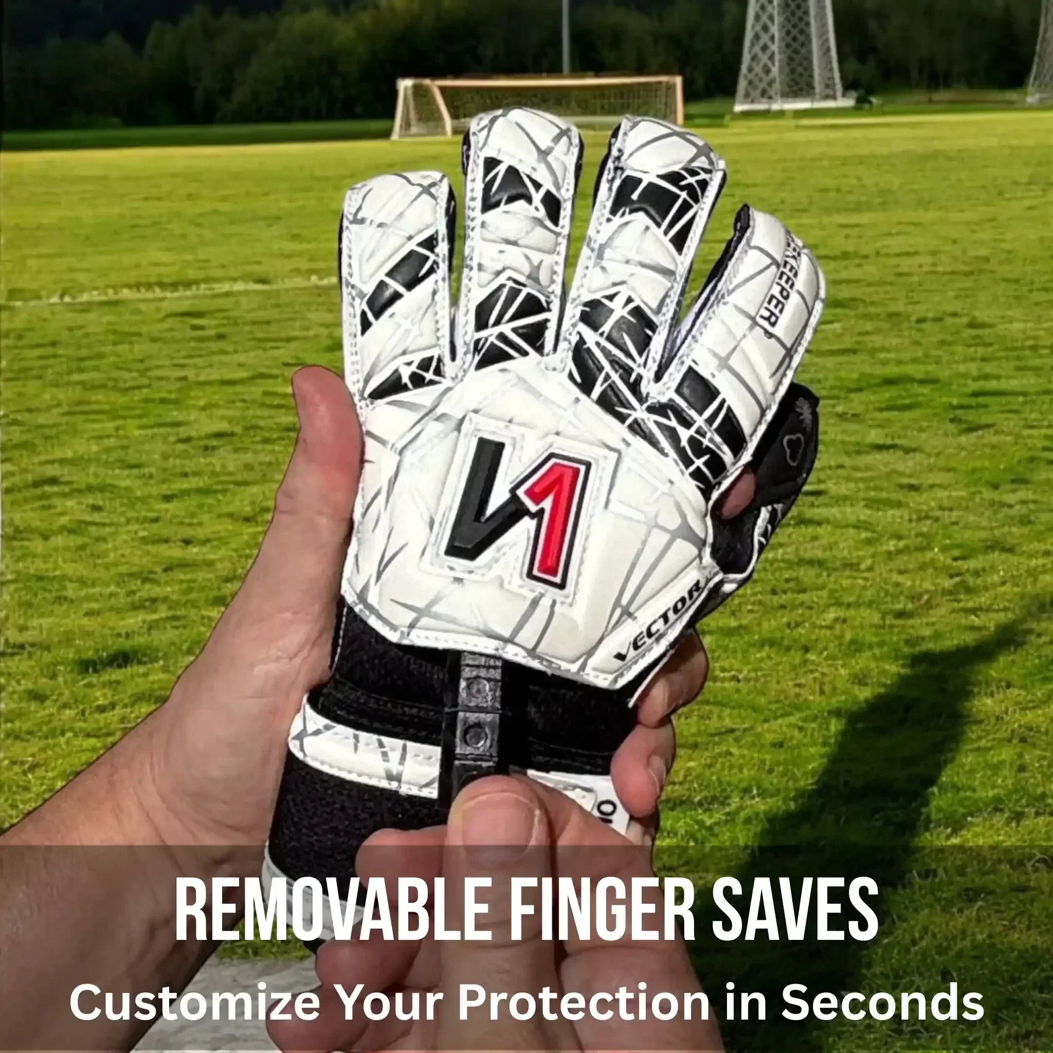 White and black youth goalkeeper glove with removable finger saves, shown on soccer field for customizable protection.