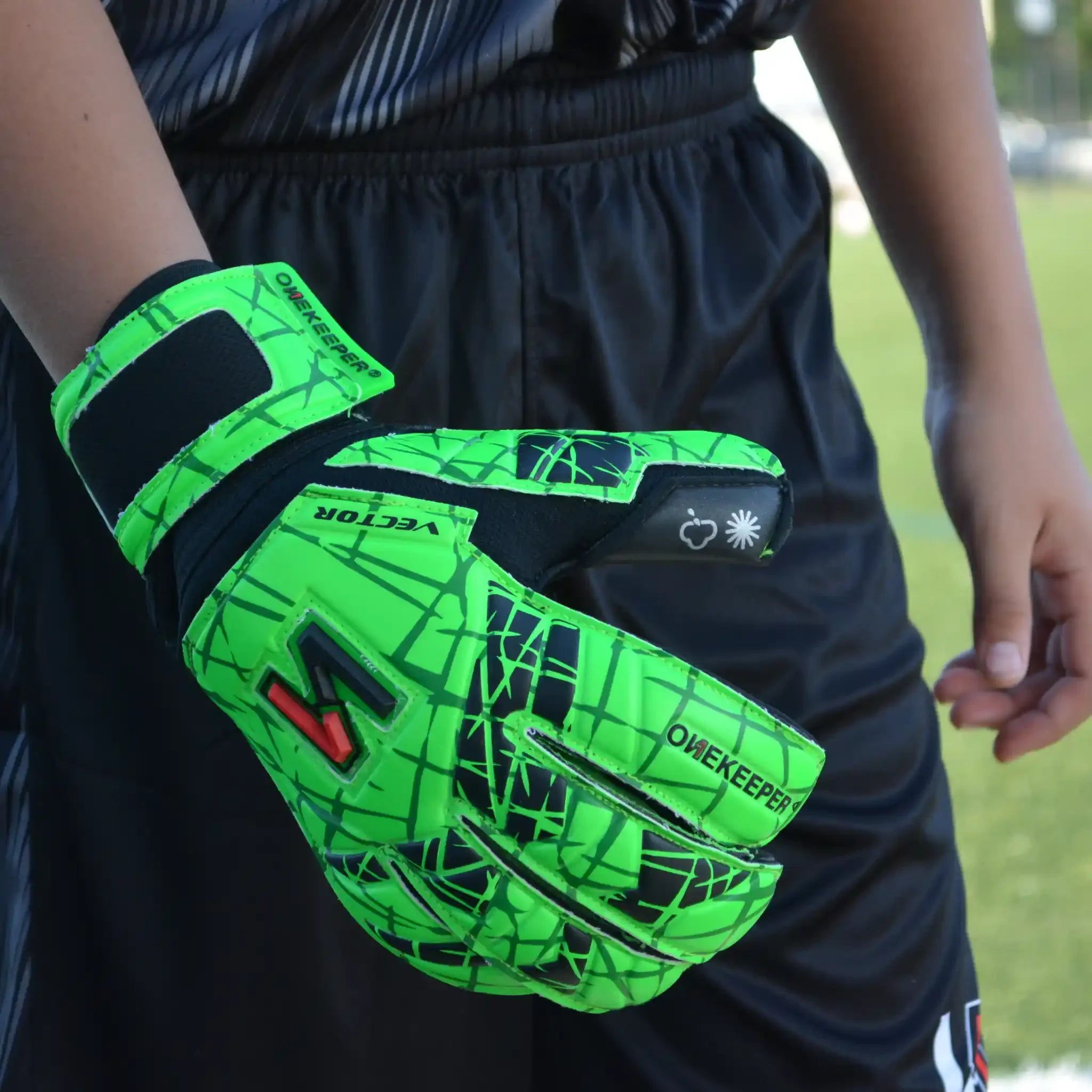 ONEKEEPER USA neon green goalkeeper glove with black accents worn on field