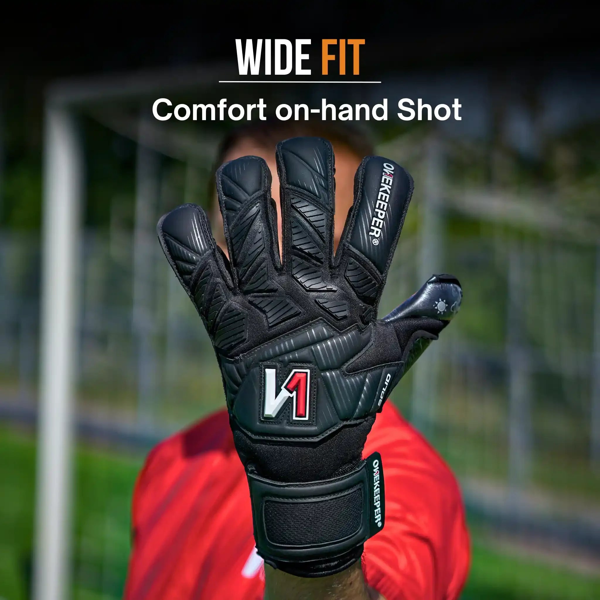 Black youth goalkeeper glove with wide fit, durable grip, and V1 logo, worn on hand for comfort and performance