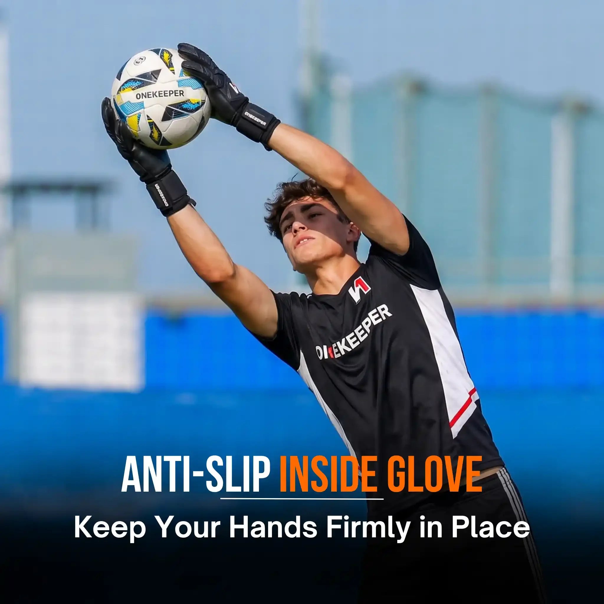 Youth goalkeeper wearing anti-slip gloves catching soccer ball on field