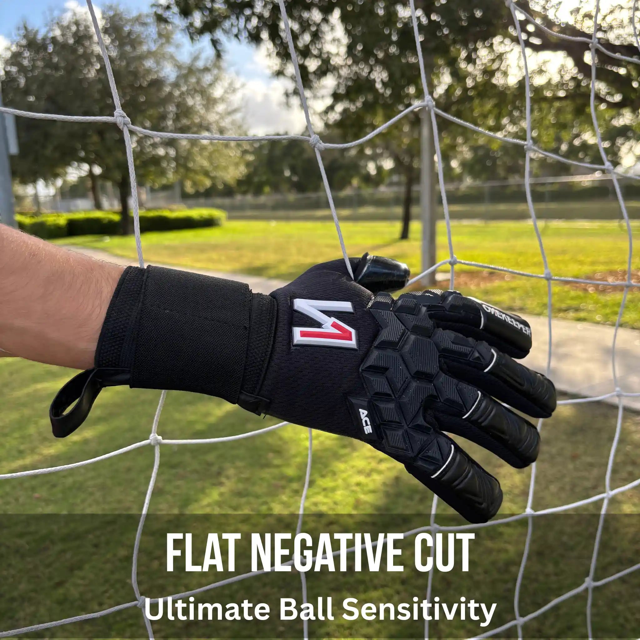 ONEKEEPER ACE Black glove with a logo on a soccer goal net, with text 'Flat Negative Cut' and 'Ultimate Ball Sensitivity'.