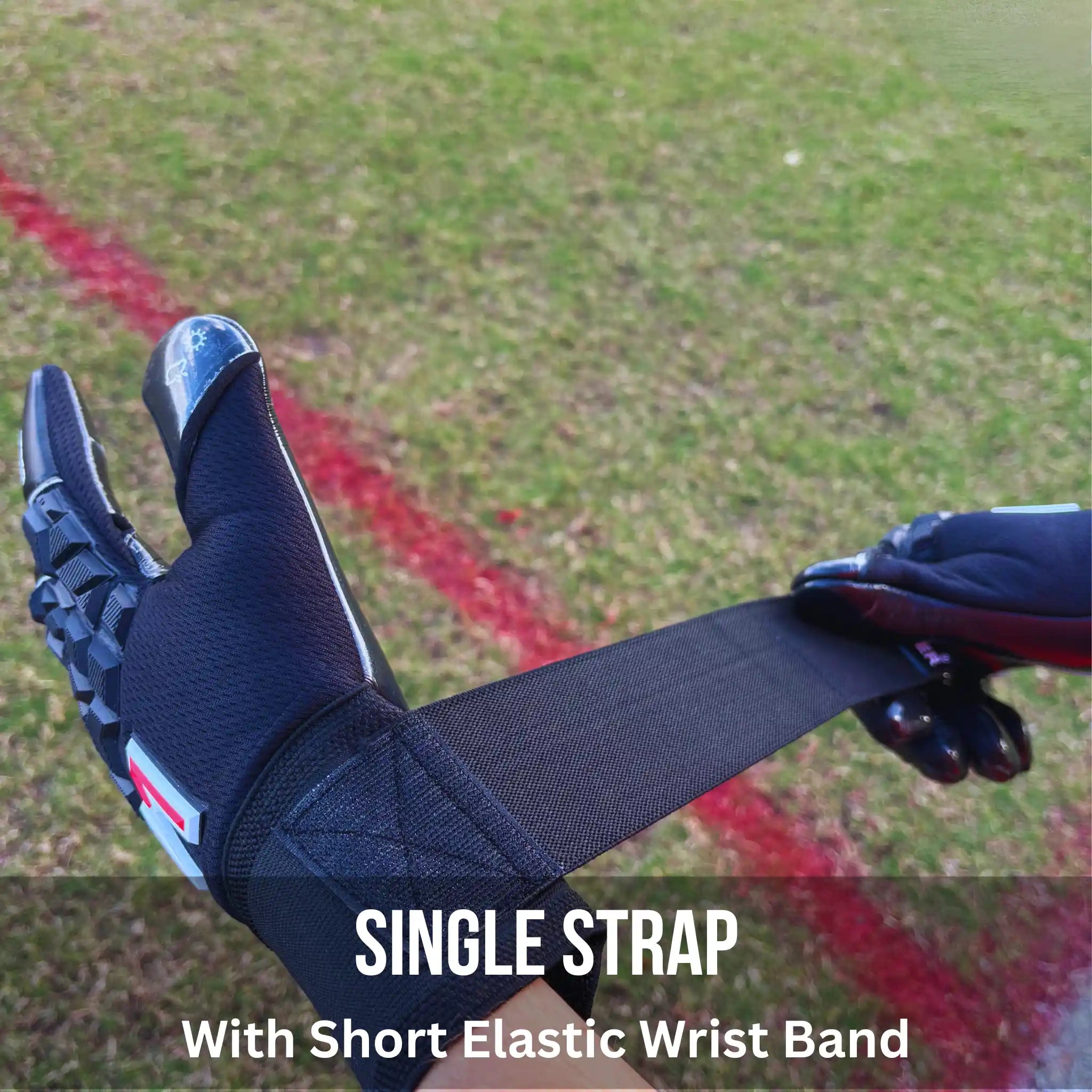 ONEKEEPER ACE Black Glove with a single strap and short elastic wrist band on grass background