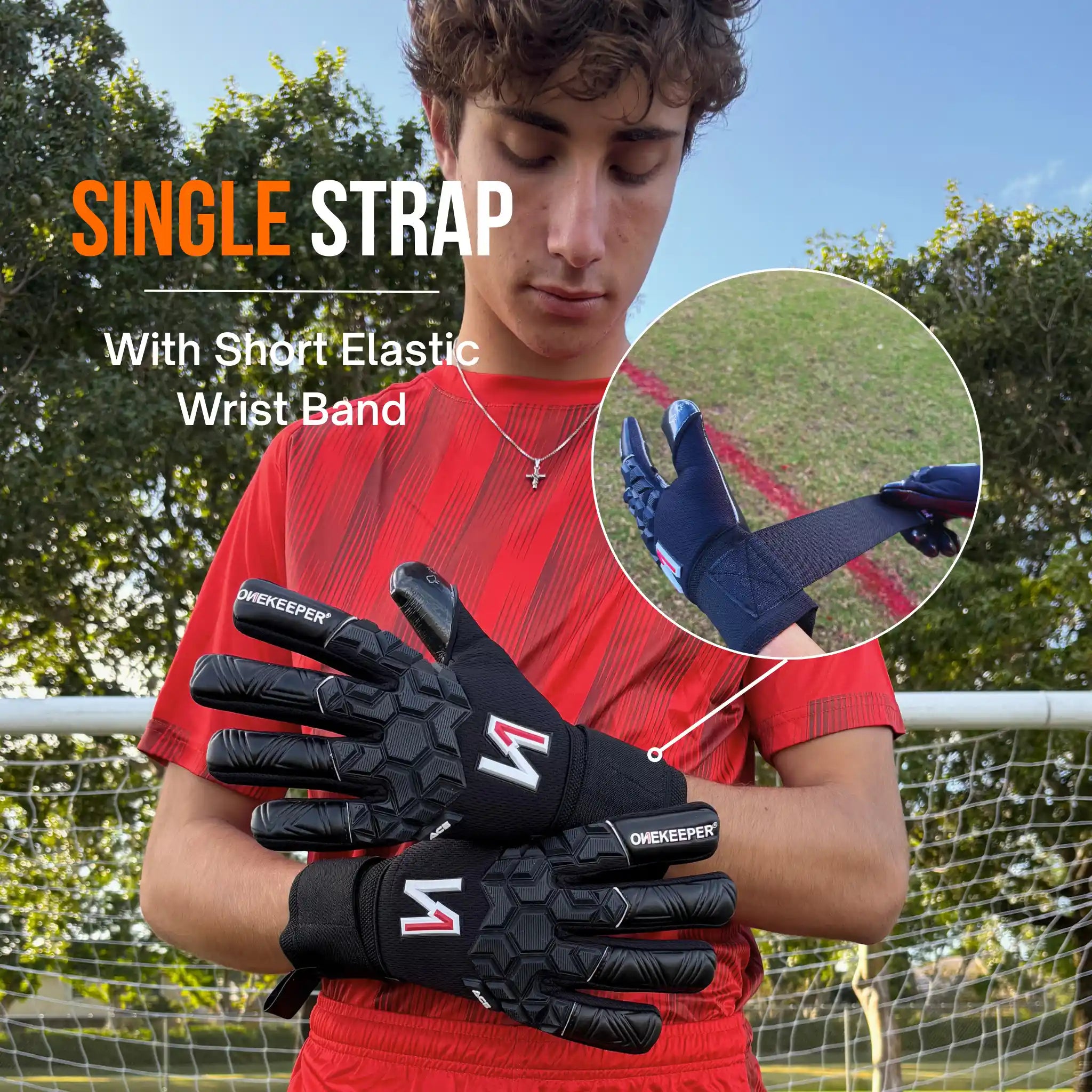 Person wearing a onekeeper ace black gloves with a single strap and short elastic wrist band, outdoors.