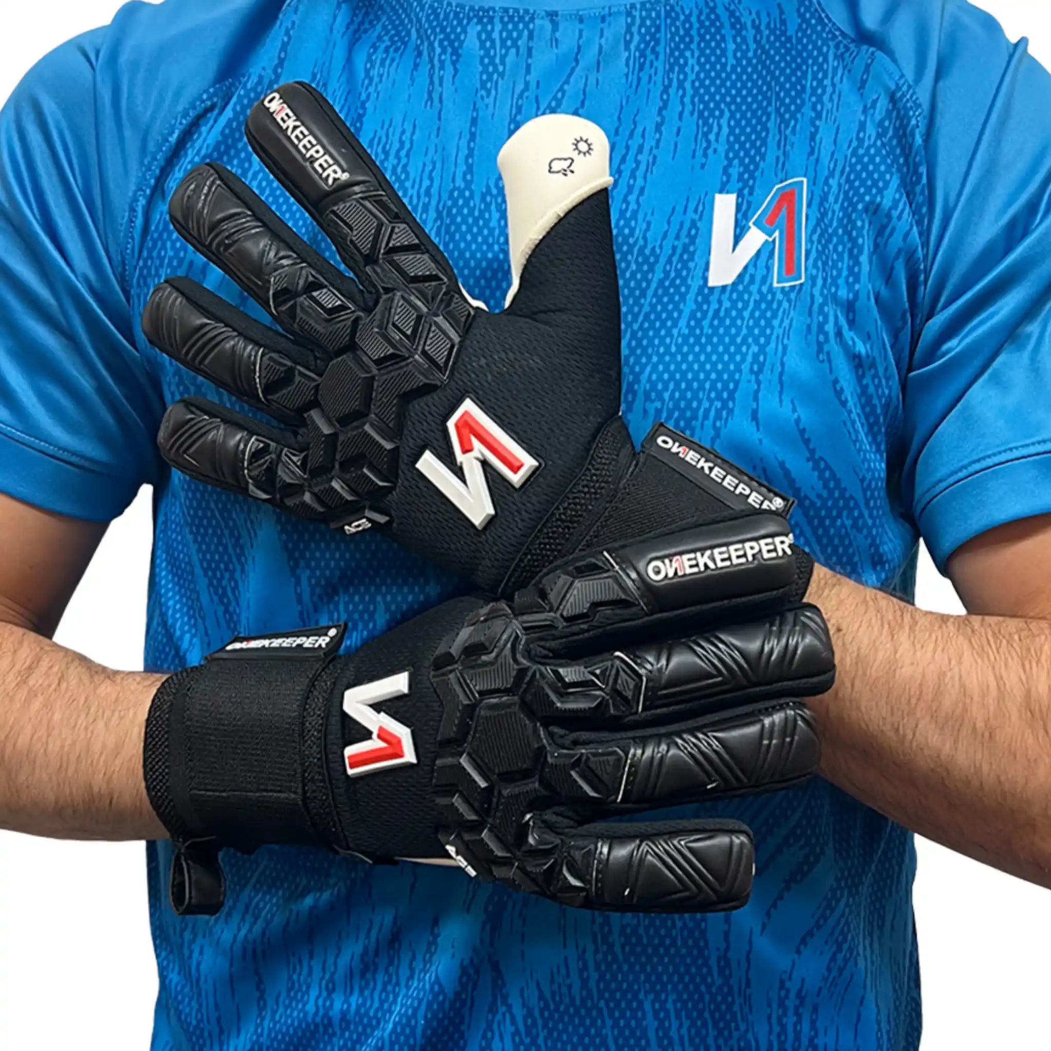 Person wearing a ONEKEEPER ACE black AND WHITE goalkeeper gloves with visible branding on a blue background