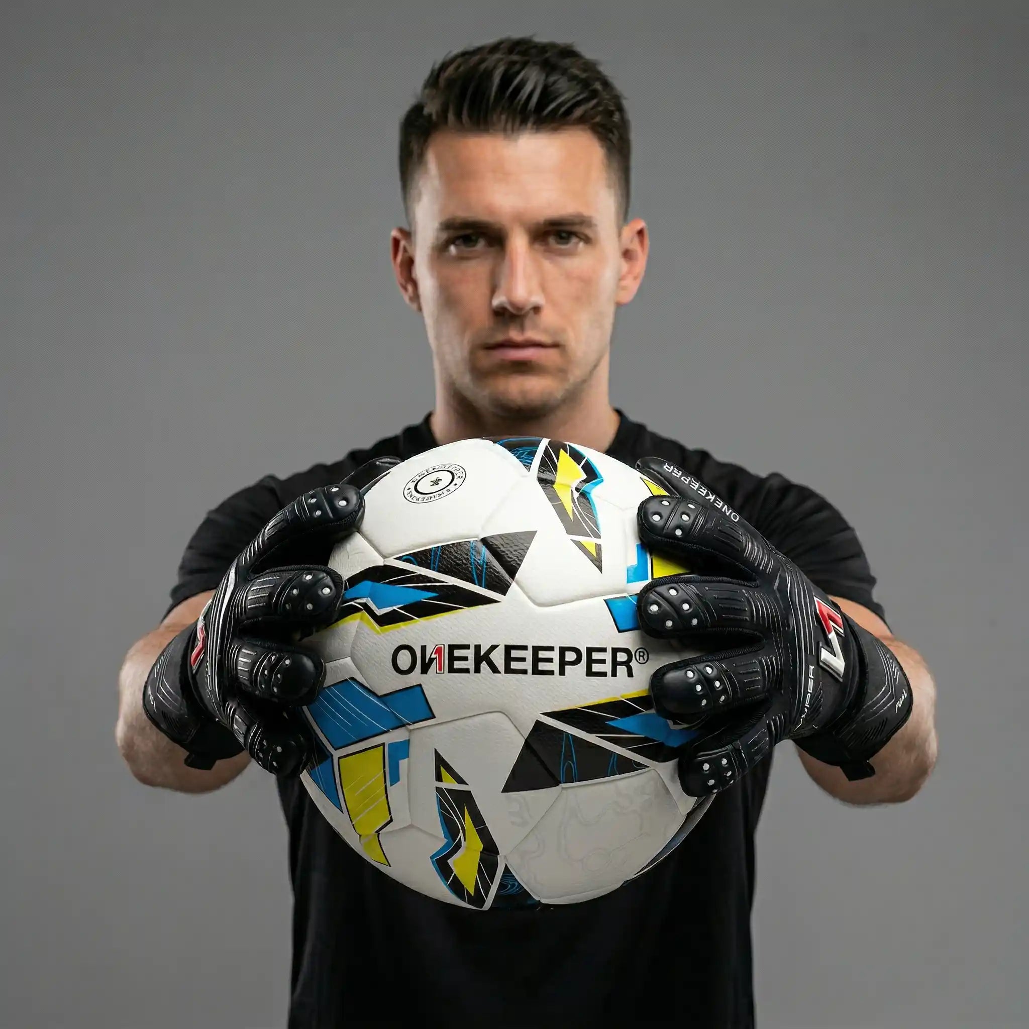 Person holding a onekeeper soccer ball branded 'Onekeeper' against a gray background