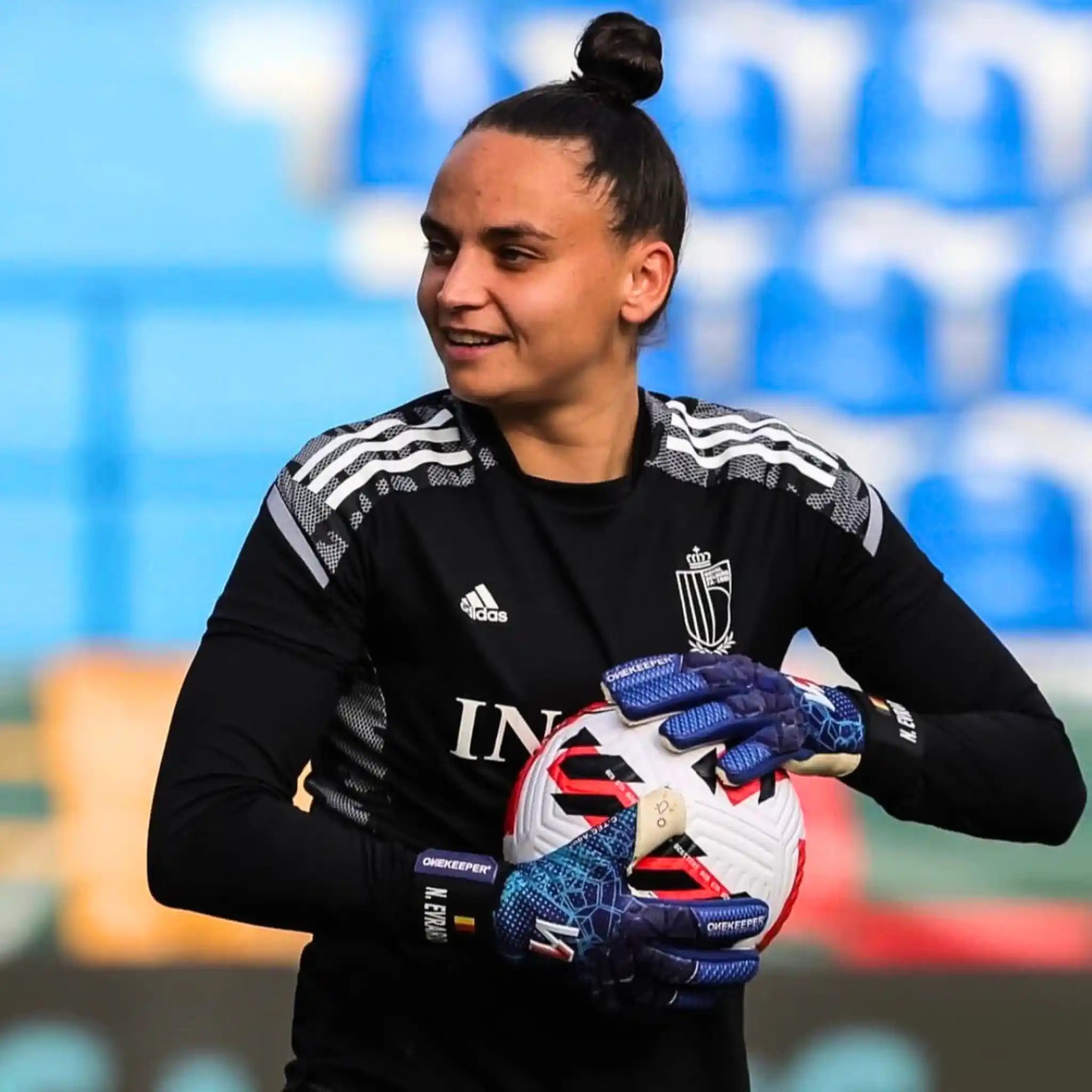Nicky holding a soccer ball on a sports field
