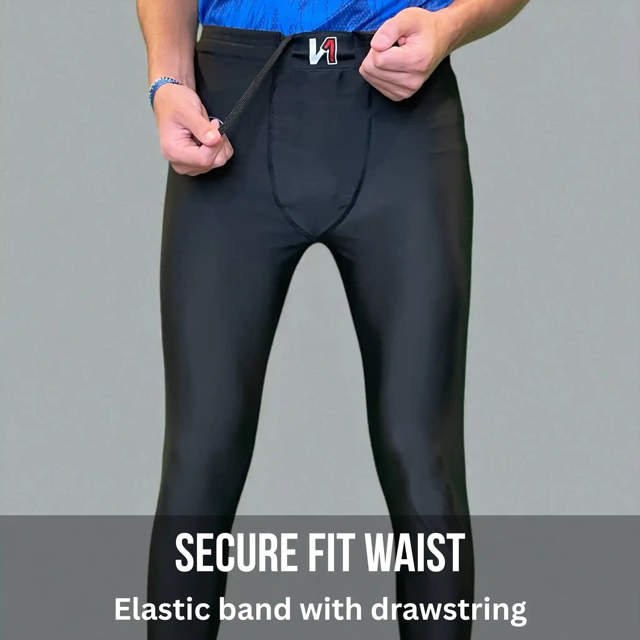 Person wearing black goalkeeper leggings with a secure fit waistband on a gray background