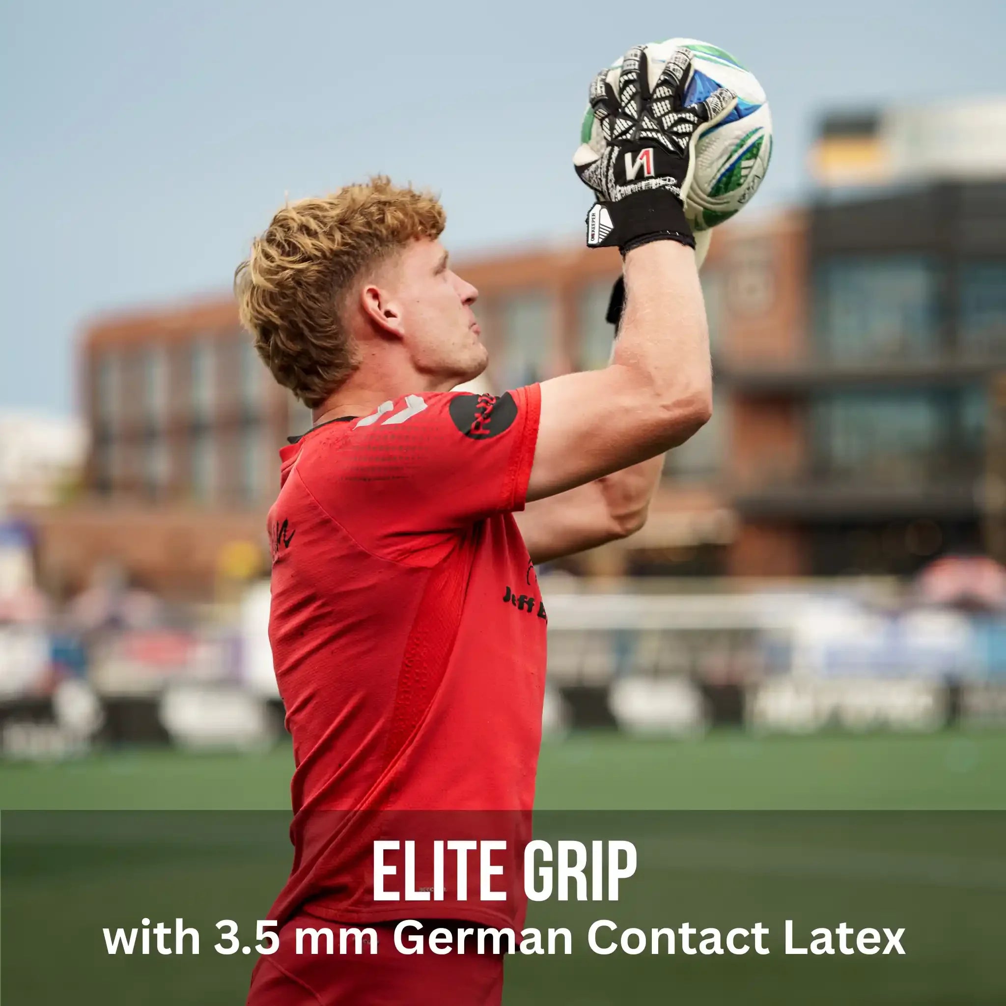 Person in red sports jersey holding a soccer ball with 'Elite Grip' text on a blurred stadium background
