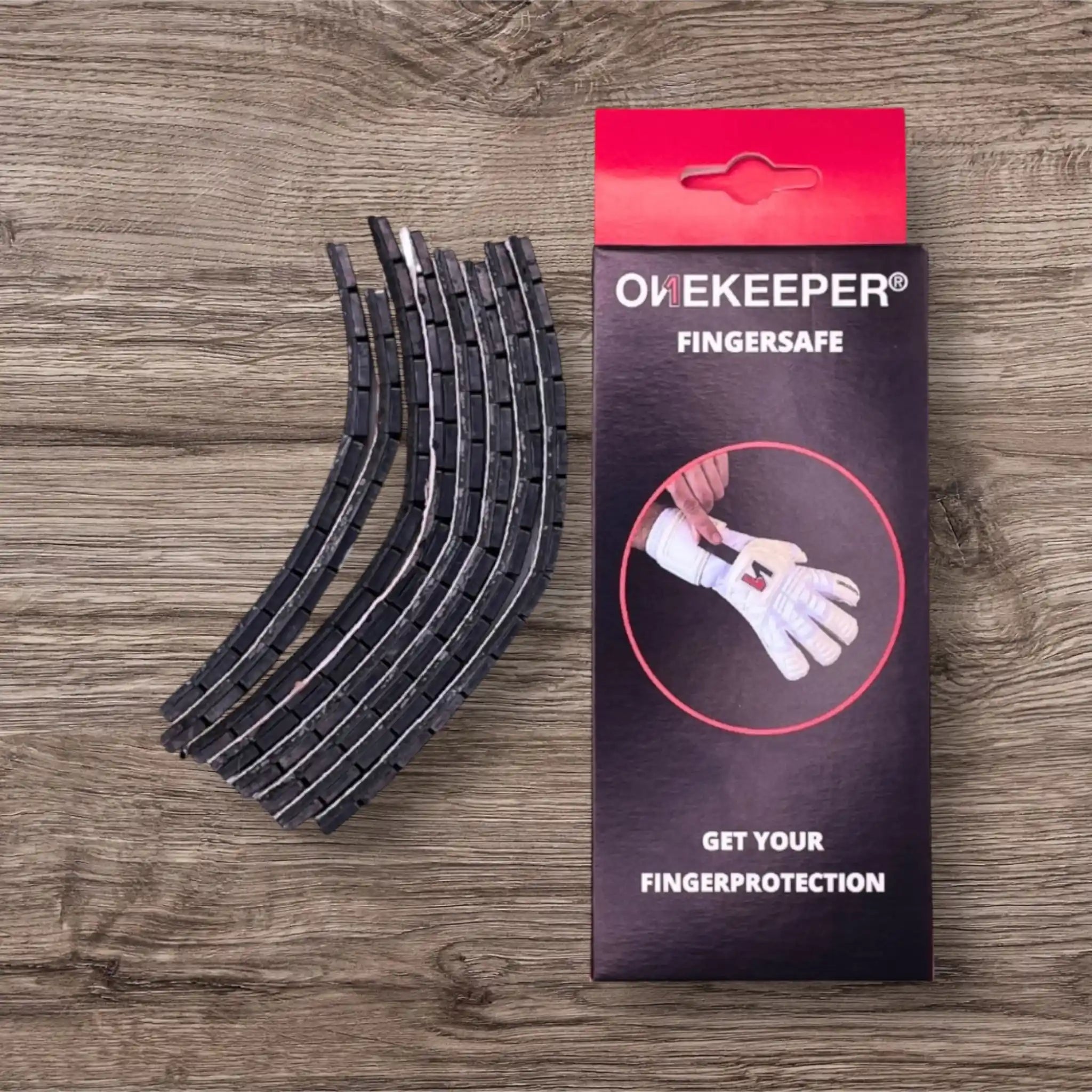 Black finger protectors and their packaging on a wooden surface