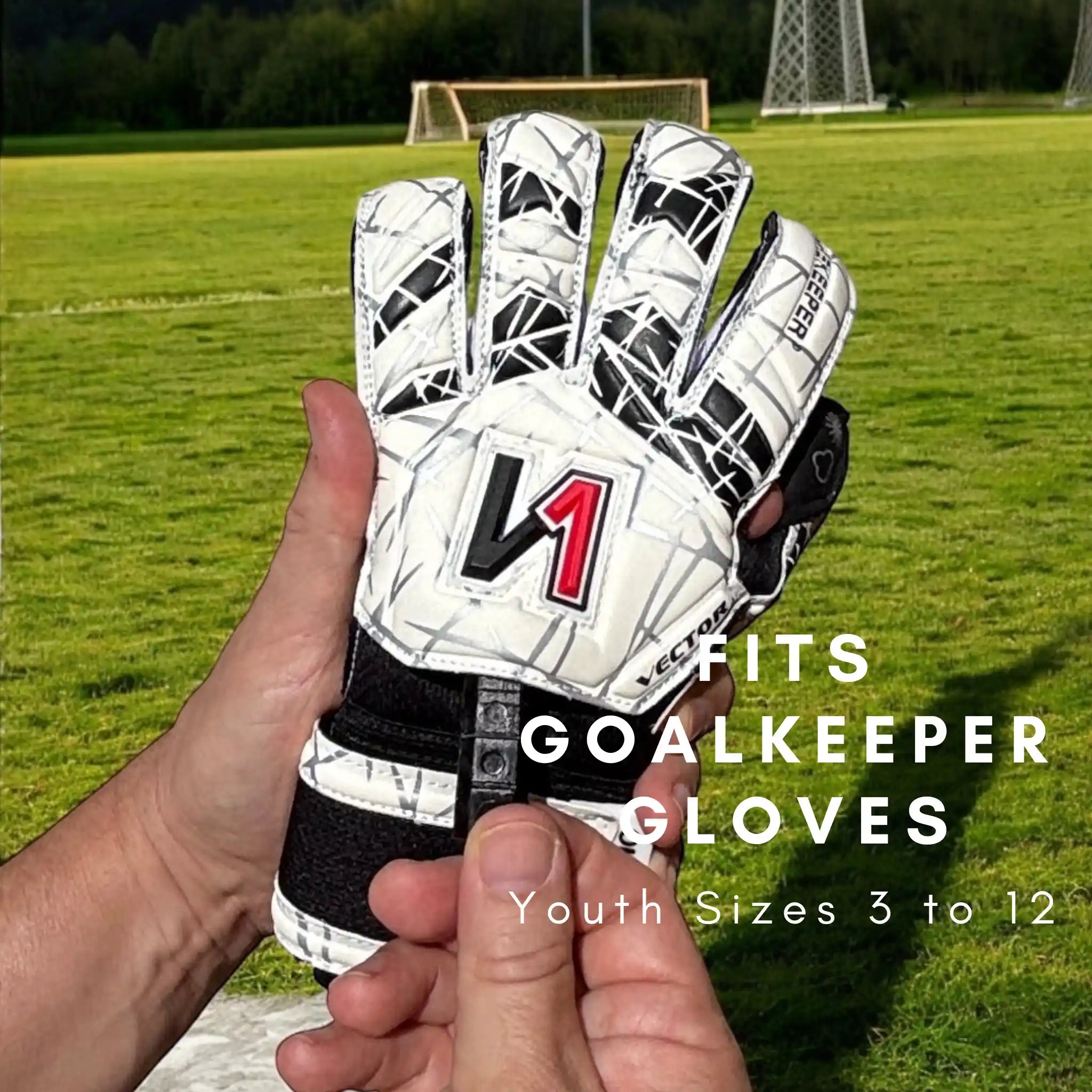 Goalkeeper glove held in a hand with a soccer field in the background