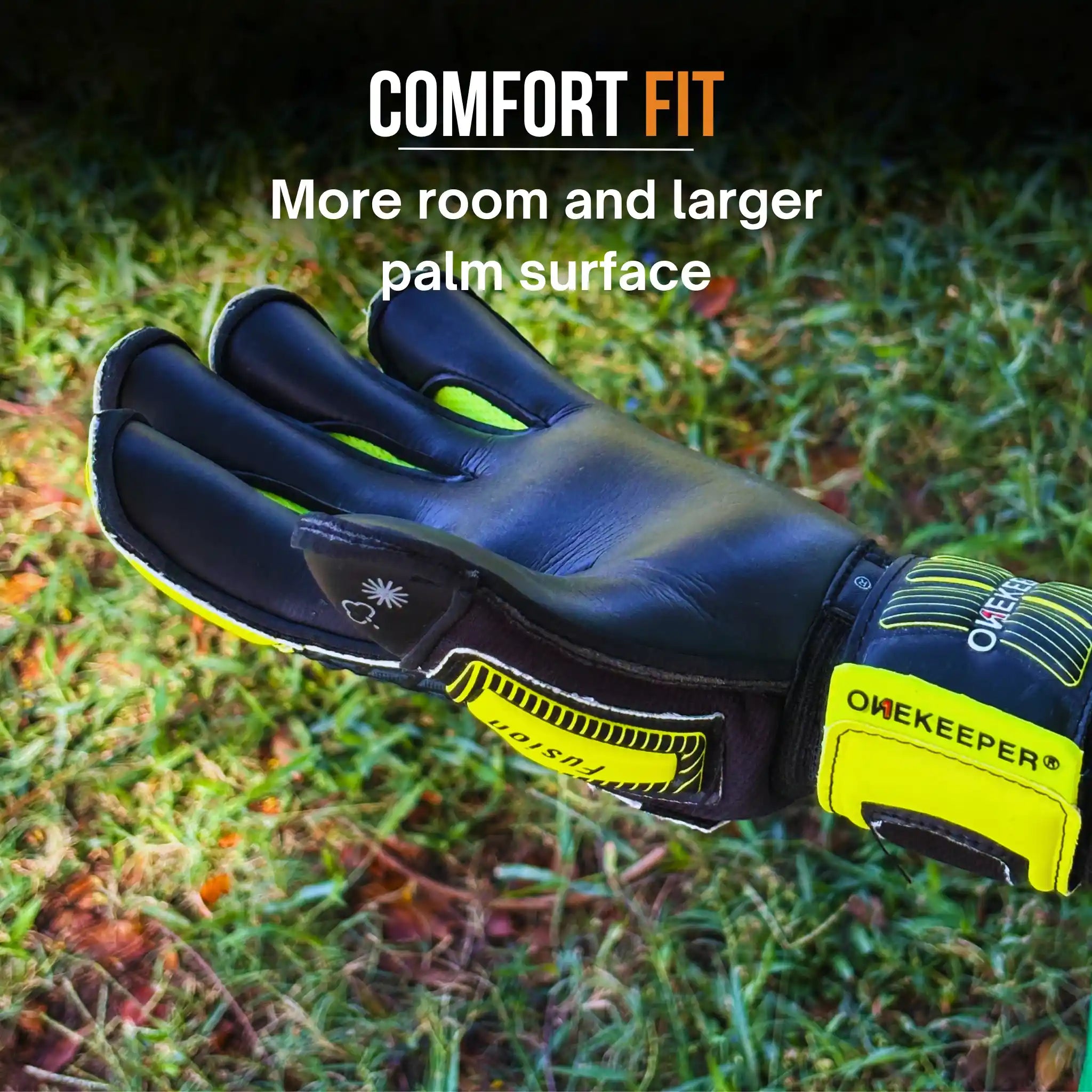 onekeeper fusion Goalkeeper glove with 'OneKeeper' branding on grass, emphasizing comfort fit.