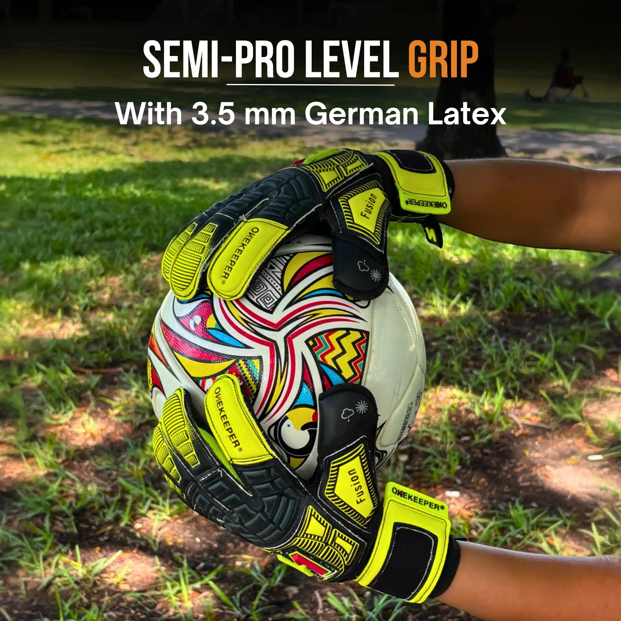 Colorful ball with onekeeper fusion gloves on a grassy background, highlighting semi-pro level grip.