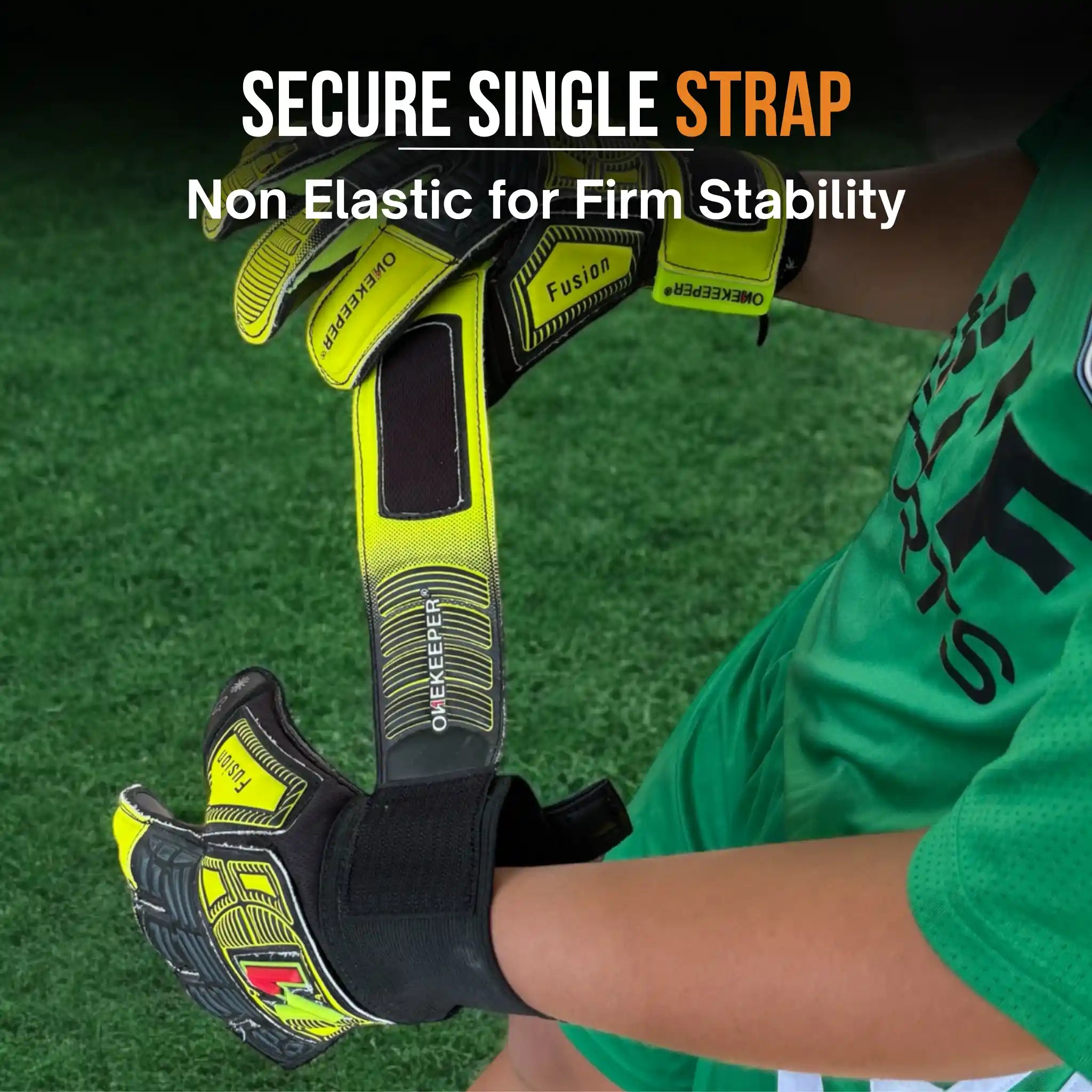 Person wearing a onekeeper fusion goalkeeper gloves with a secure single strap on a grass field background