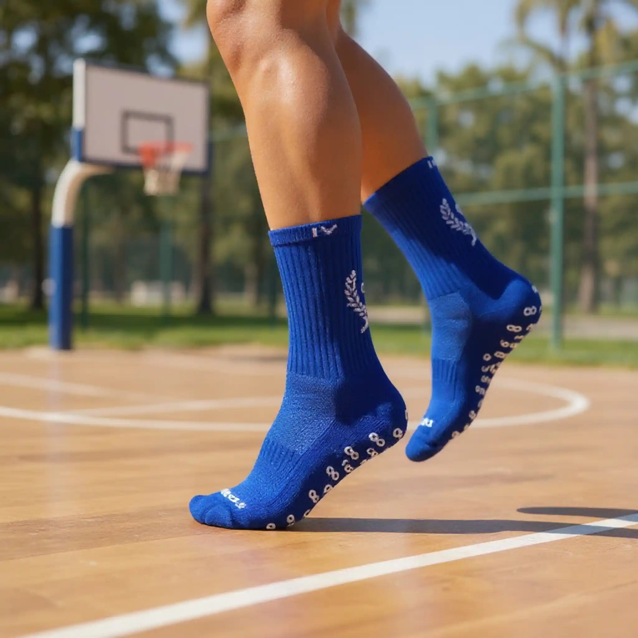 Person wearing blue grip socks with white logo on a basketball court