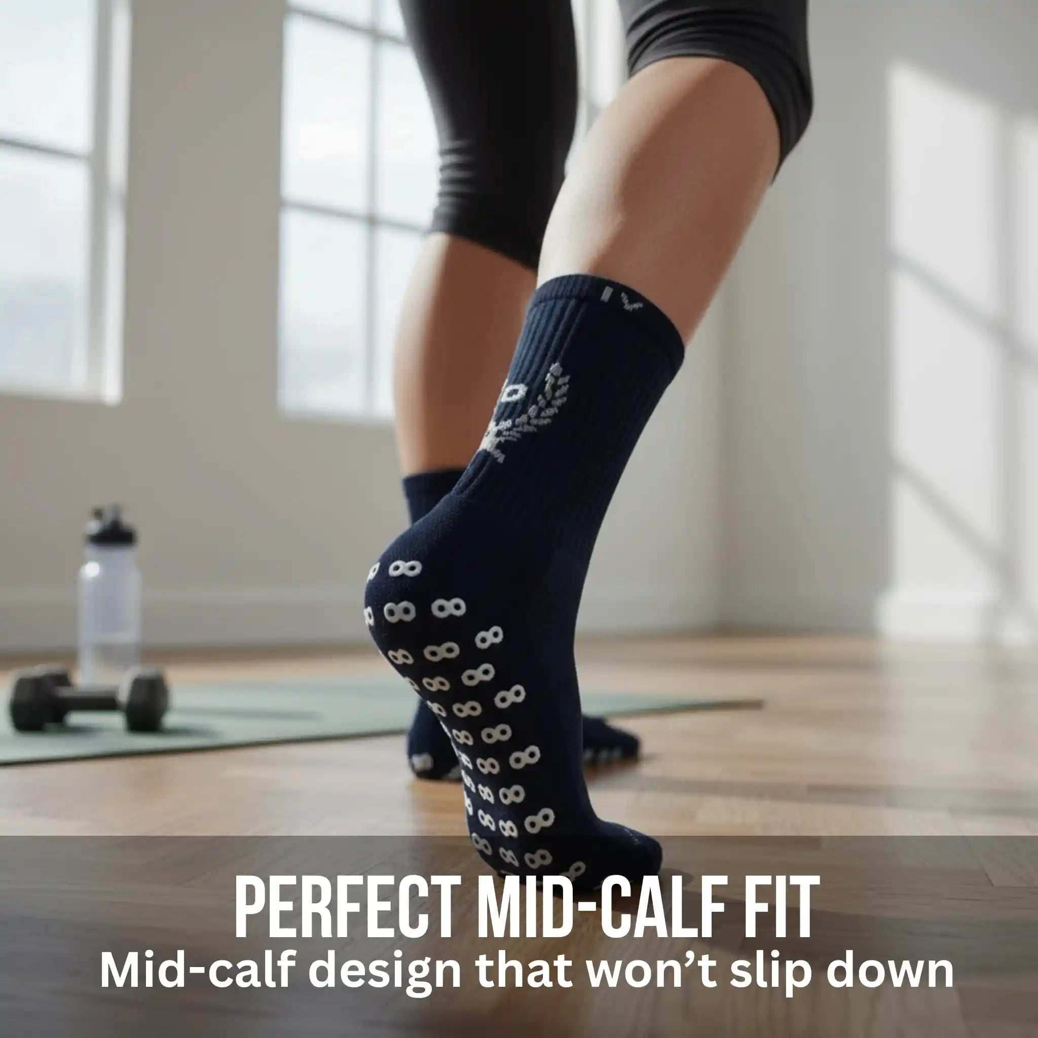 Person wearing navy grip socks with a pattern in a room with large windows.