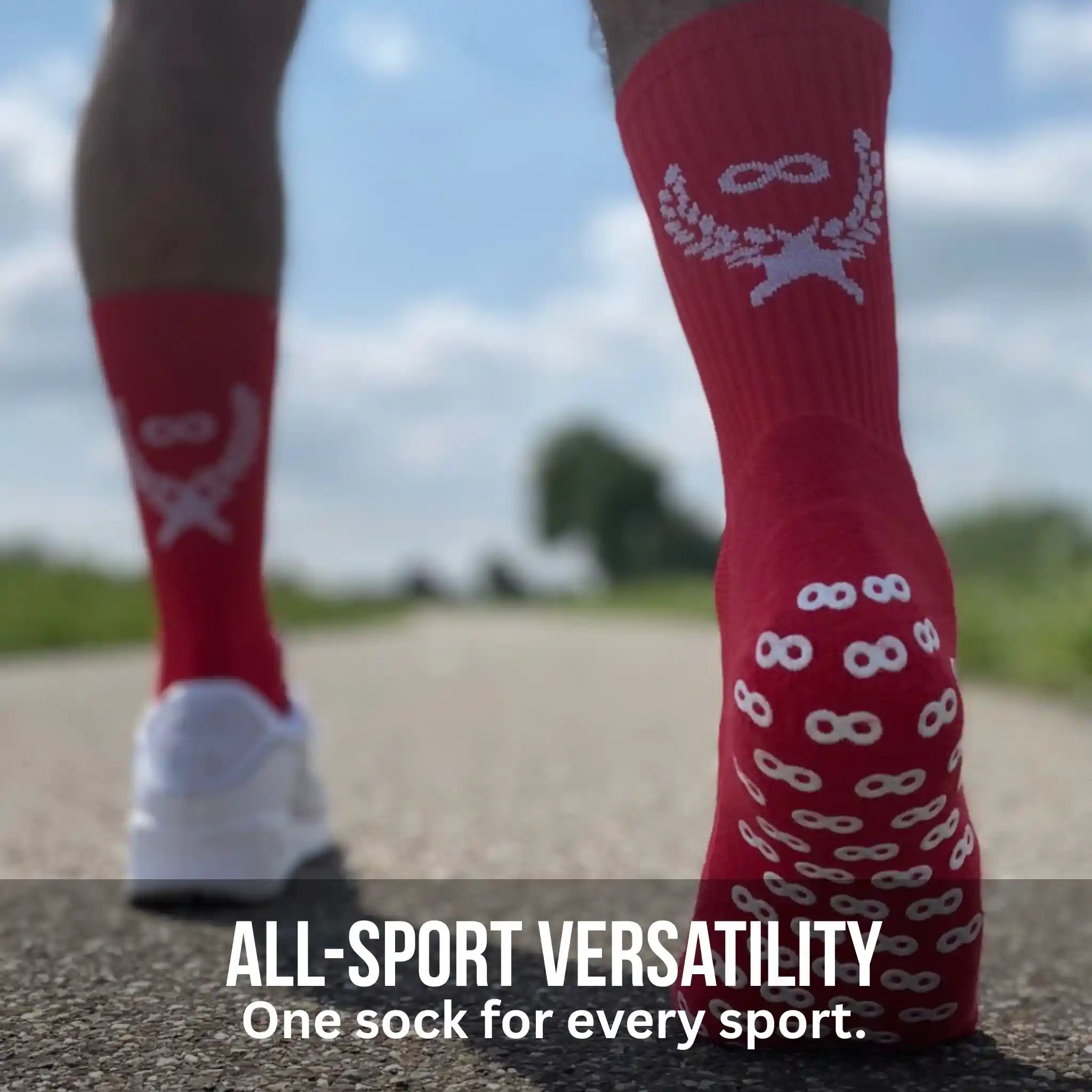 Red grip socks with white patterns worn by a person on a road with 'All-Sport Versatility' text.