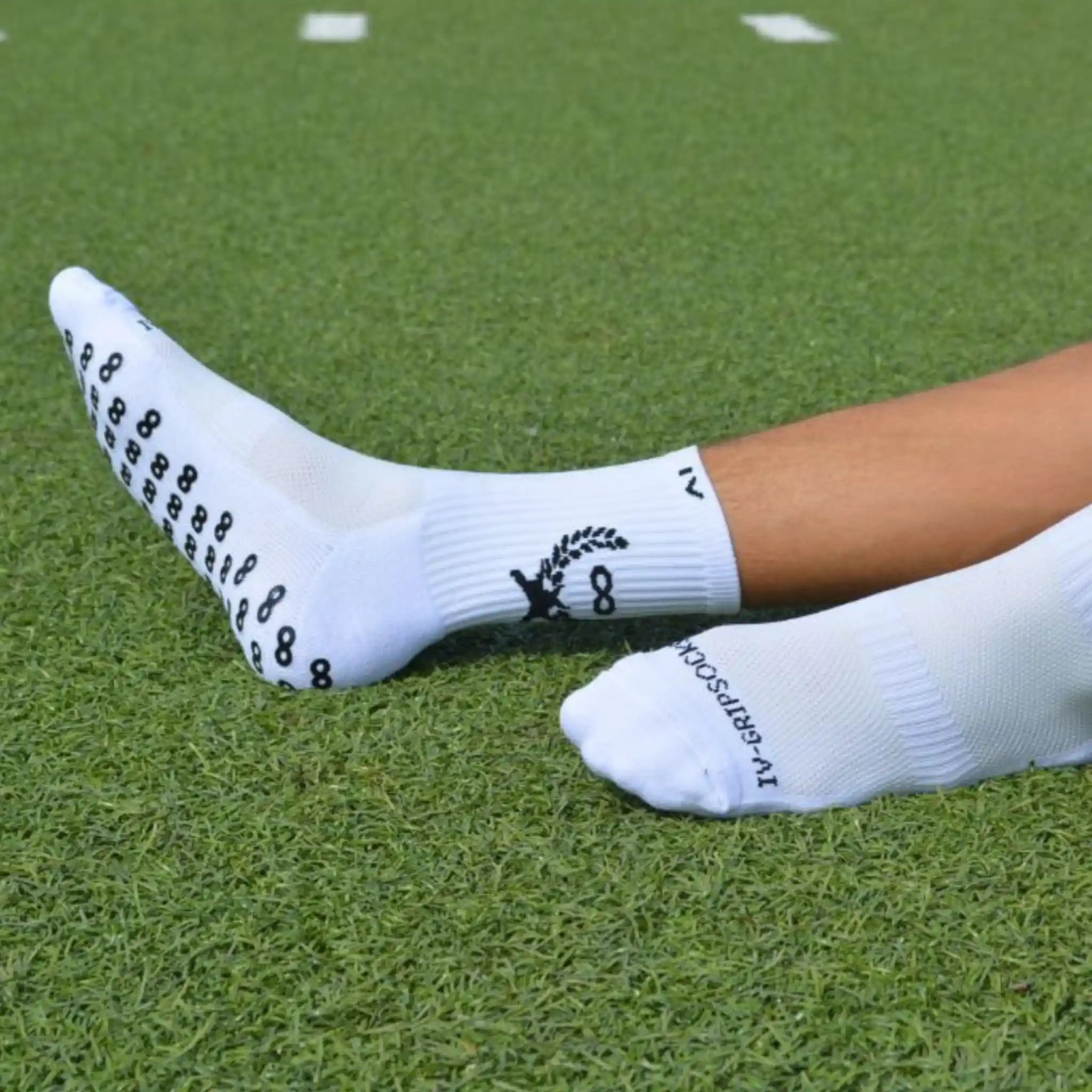White grip socks with black patterns on a grassy field