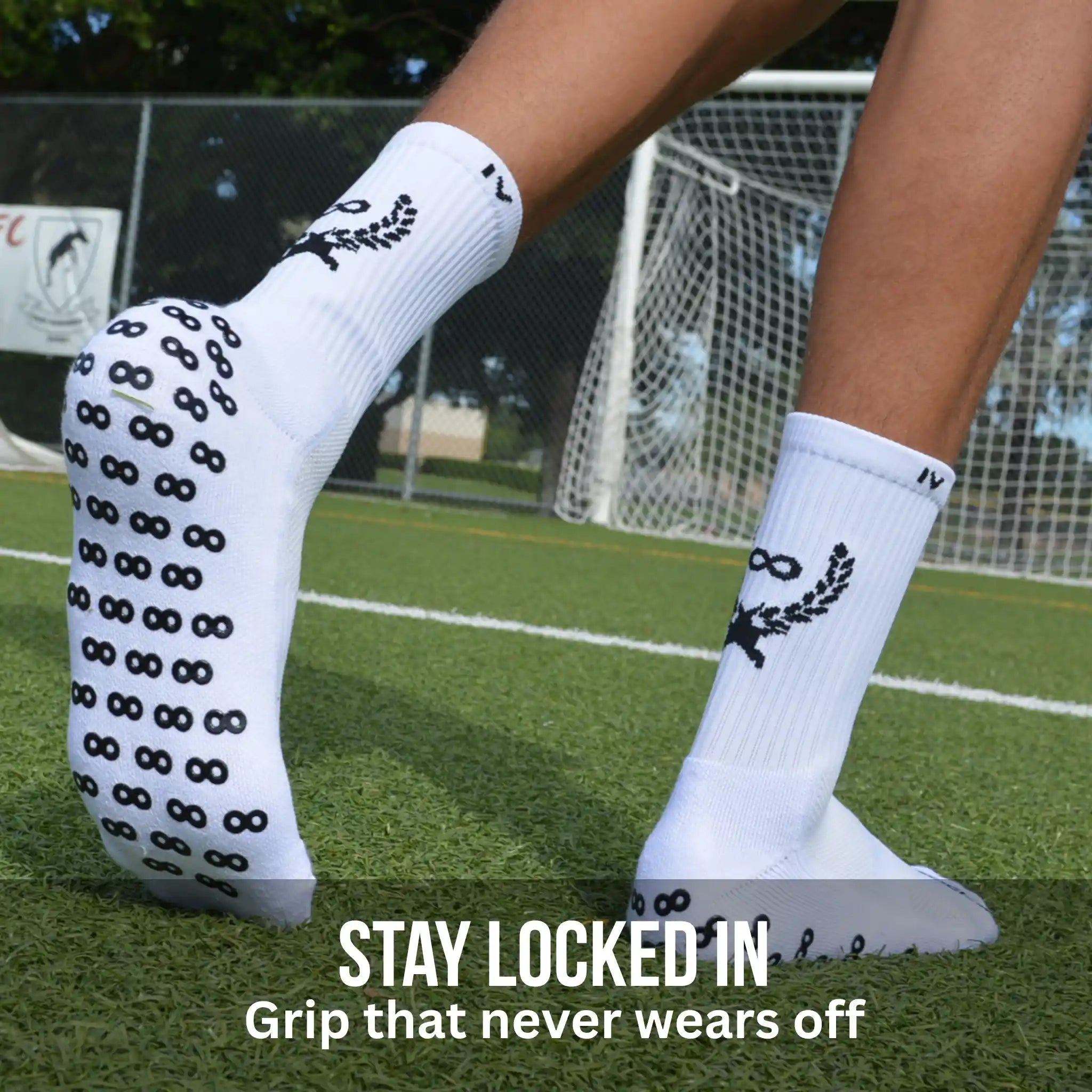 White grip socks with black patterns on a grassy field, promoting 'Stay Locked In' grip.