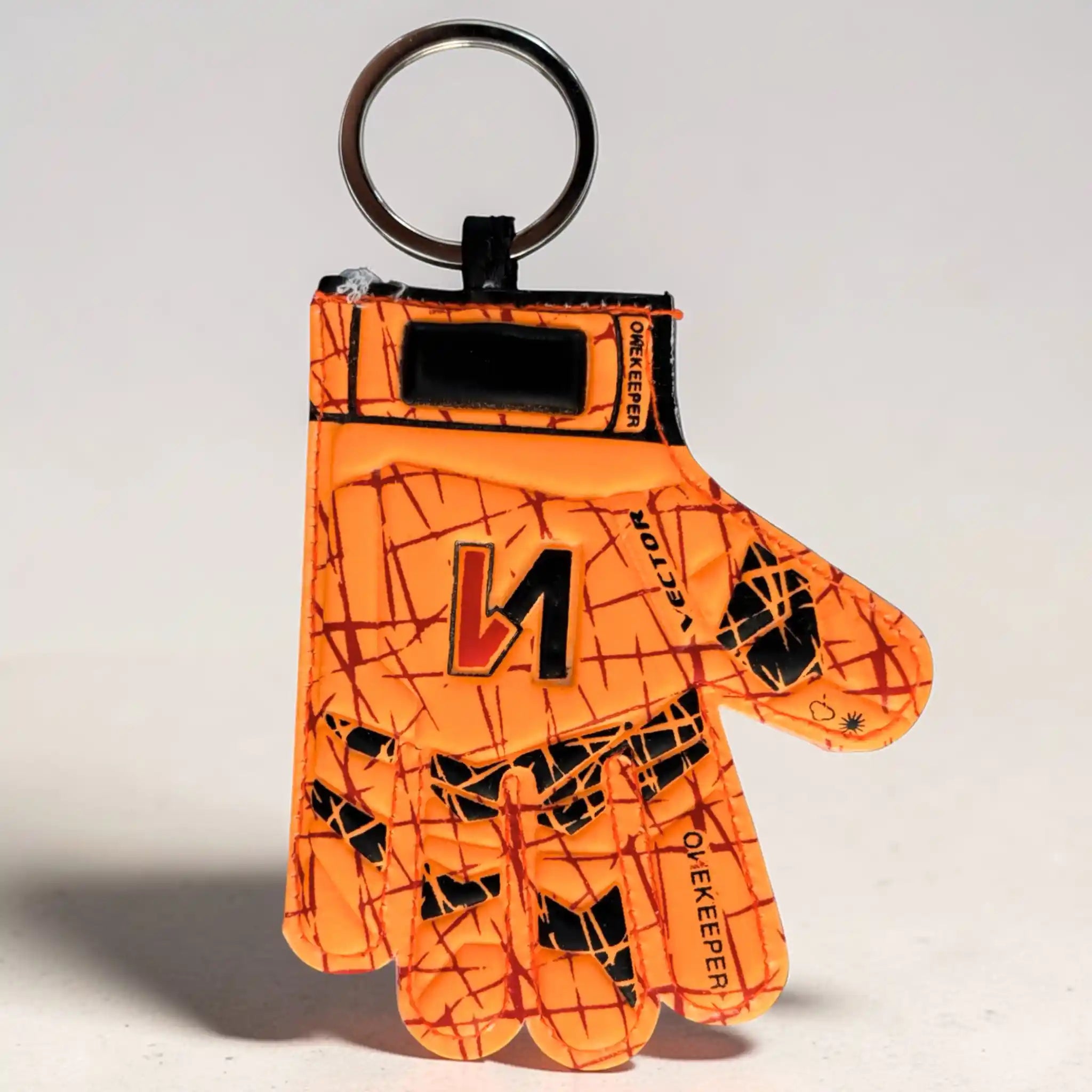 onekepeer Orange keychain with black patterns and a logo on a light gray background