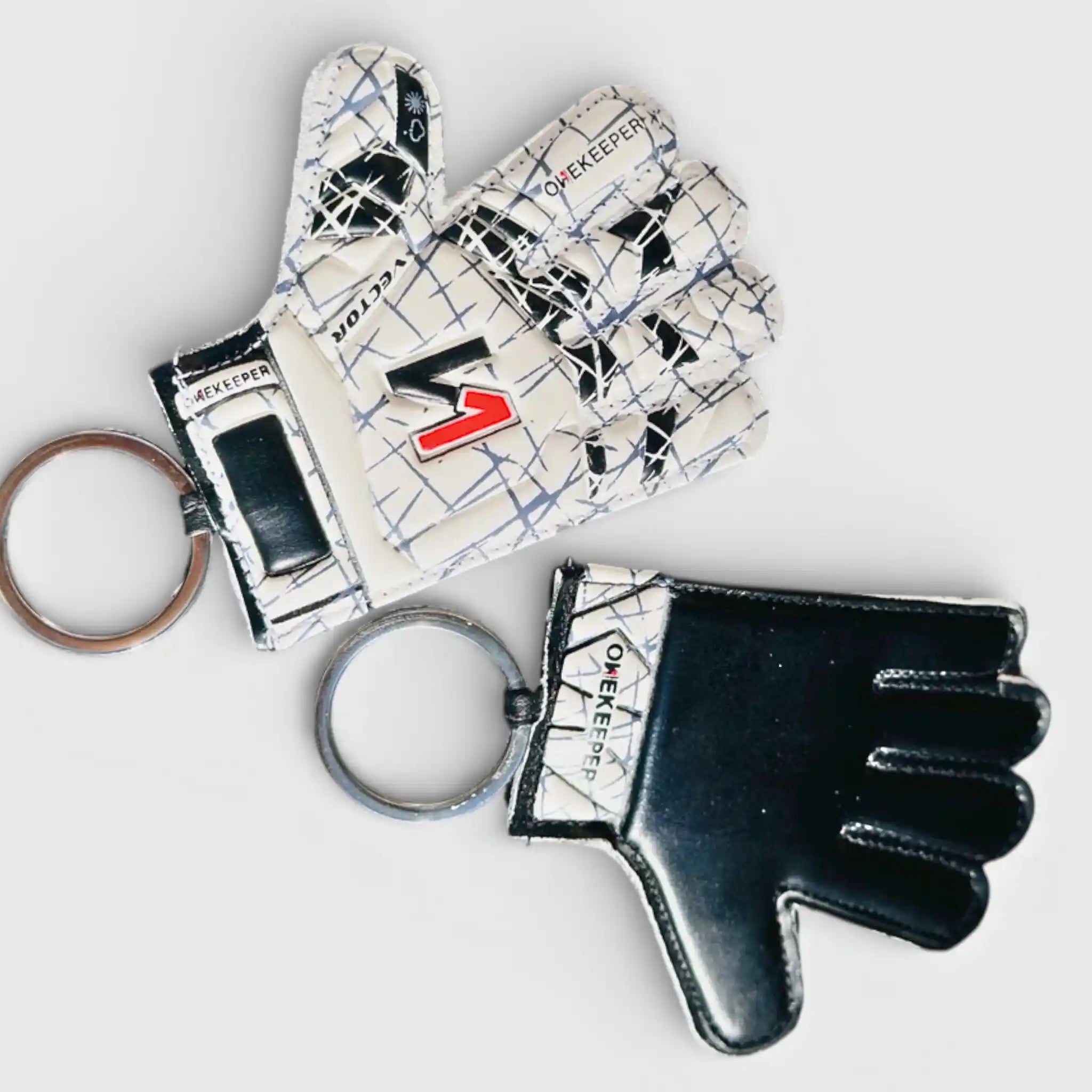 Glove-shaped onekeeper vector evolution white and black keychains with a brand logo on a light gray background