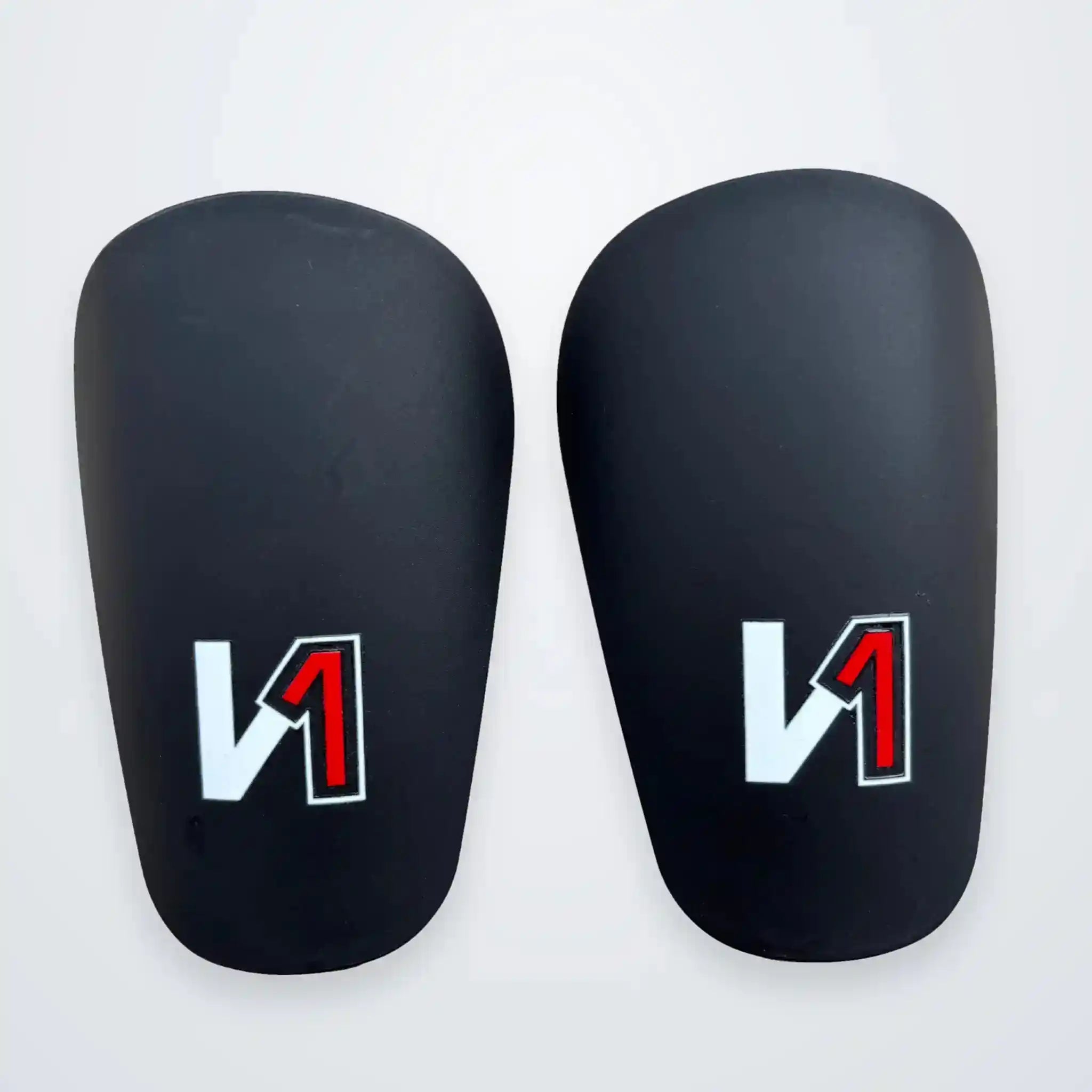 A pair of onekeeper mini shin guards with a white and red stylized 'N1' logo on a clean white background.