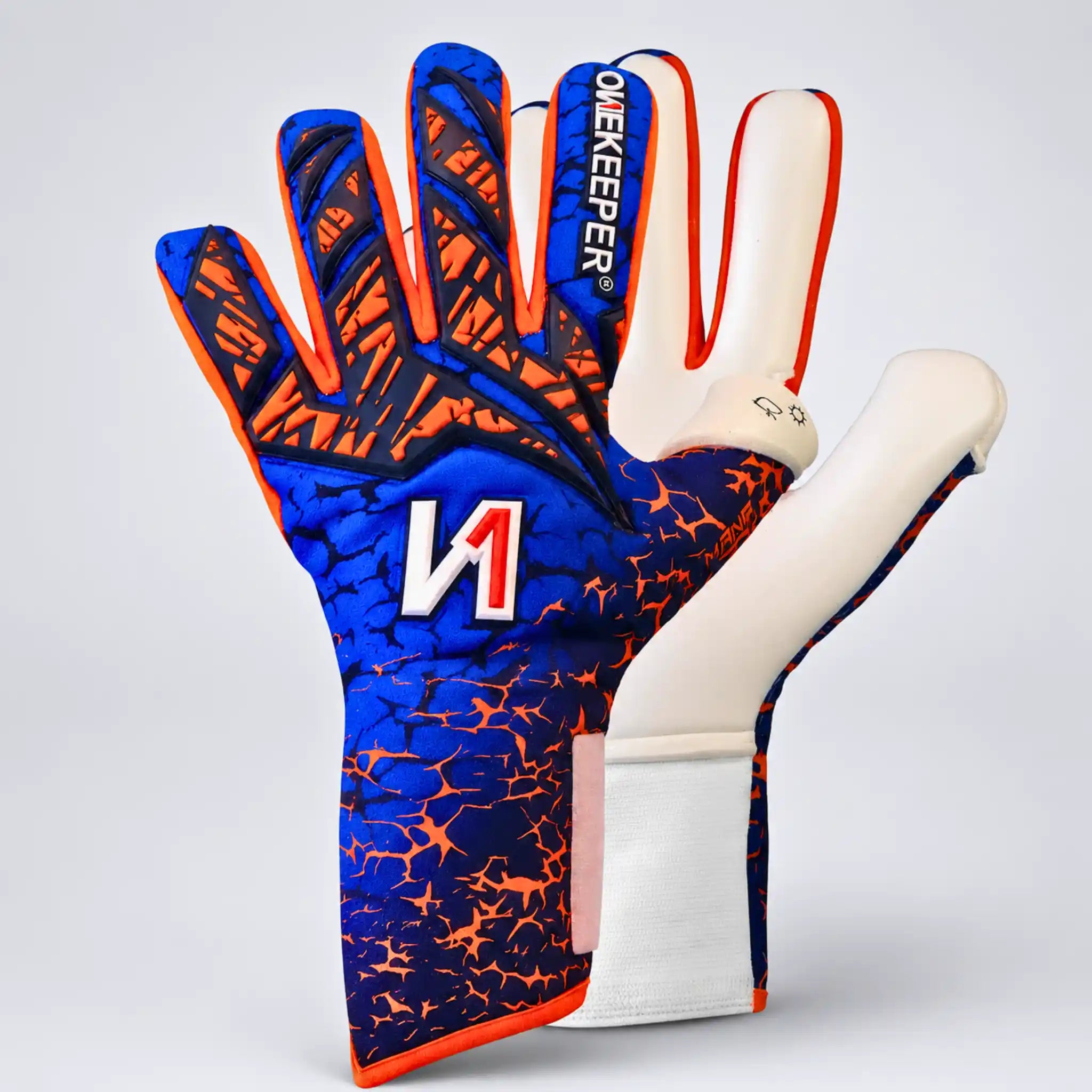 A pair of onekeeper mana blue and orange goalkeeper gloves shown against a light gray studio background. One glove is oriented to show the back of the hand with a blue and orange crackle pattern, white finger pads, and the brand name 'ONEKEEPER' printed vertically.
