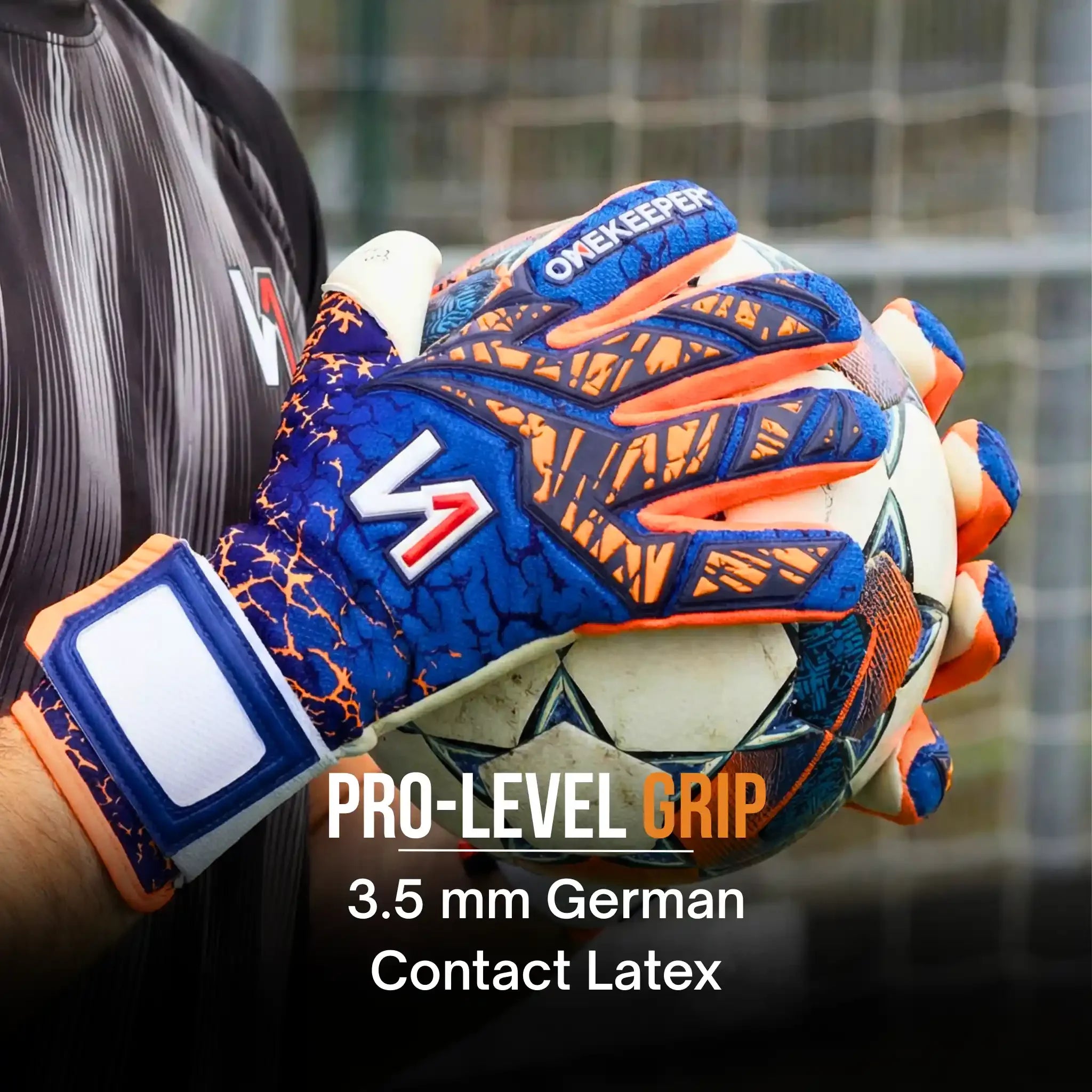 Goalkeeper wearing the onekeeper mana blue and orange latex gloves holds soccer ball in front of goal net.