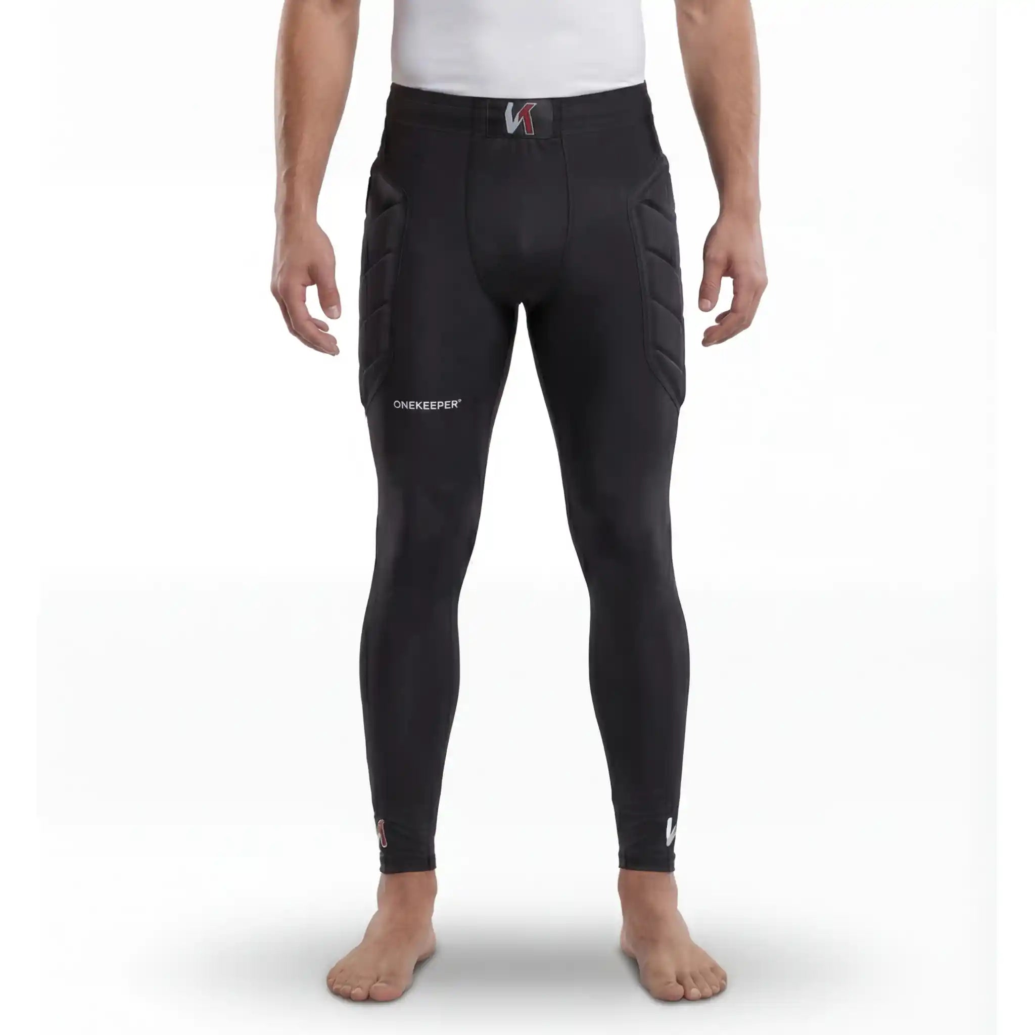 Person wearing black compression-padded leggings on hip only with visible branding on a white background