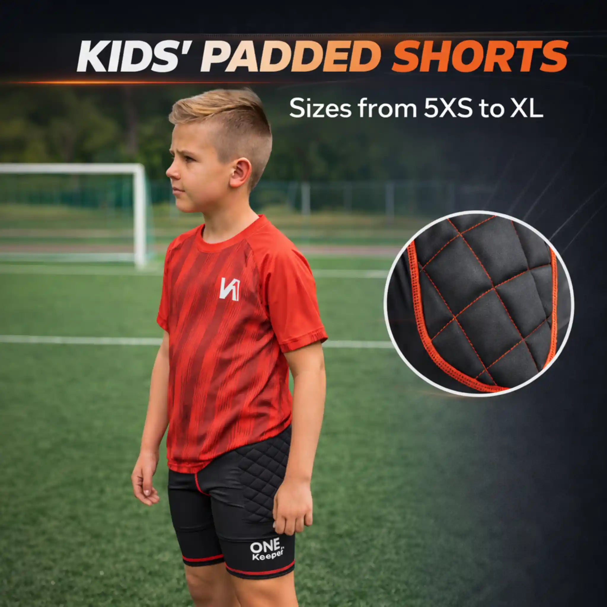 Child wearing red sports shirt and onekeeper black padded shorts with padding detail on a sports field background