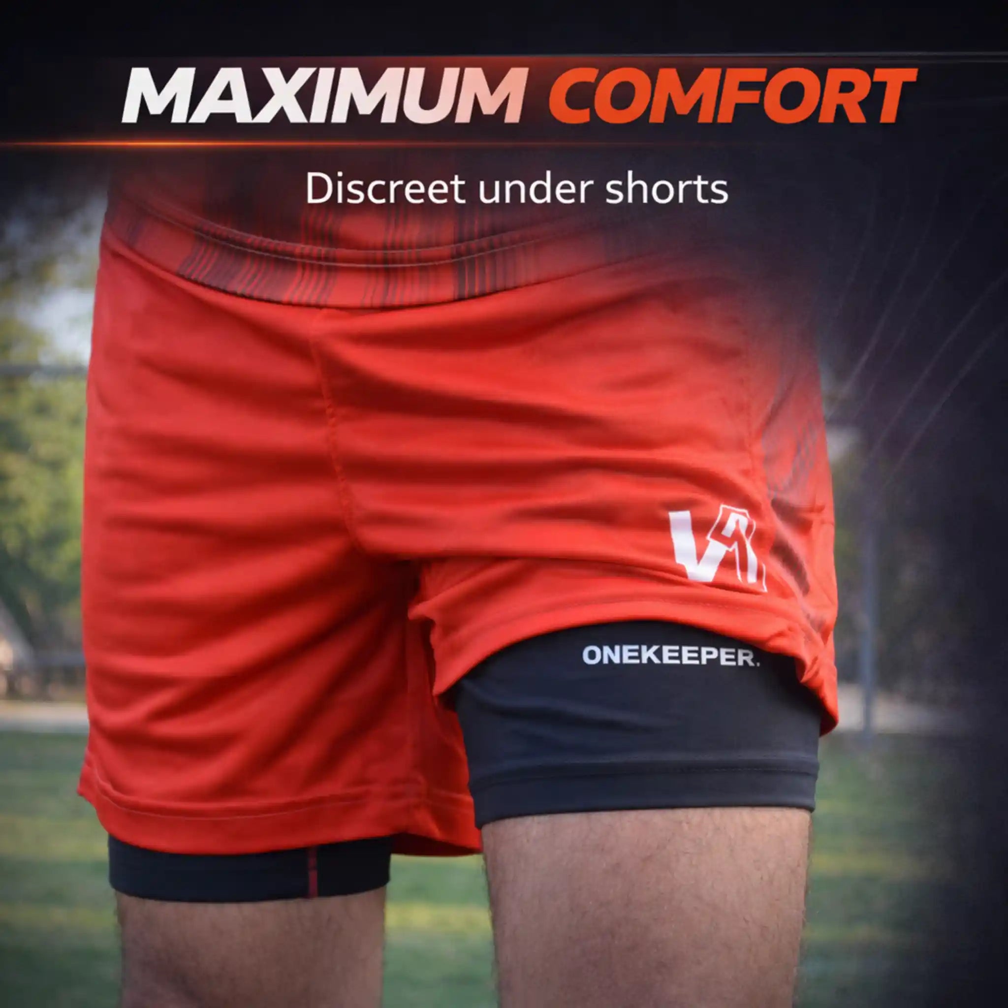 Red athletic shorts with a logo on a blurred sports field background, emphasizing 'Maximum Comfort' and 'Discreet under shorts'.