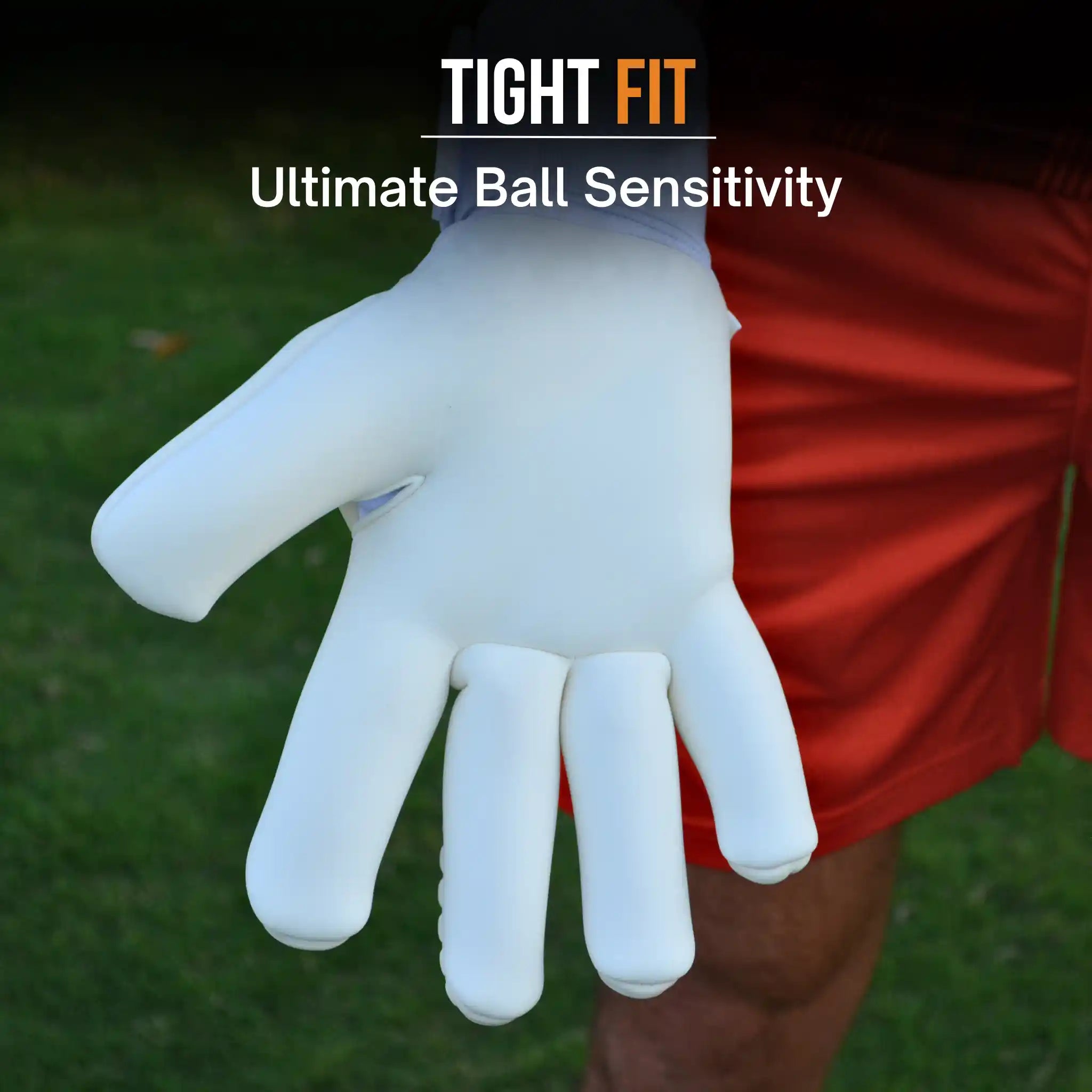 onekeeper philipp kohn White soccer glove on a person's hand with red shorts, on a grassy background, featuring 'Tight Fit' text.