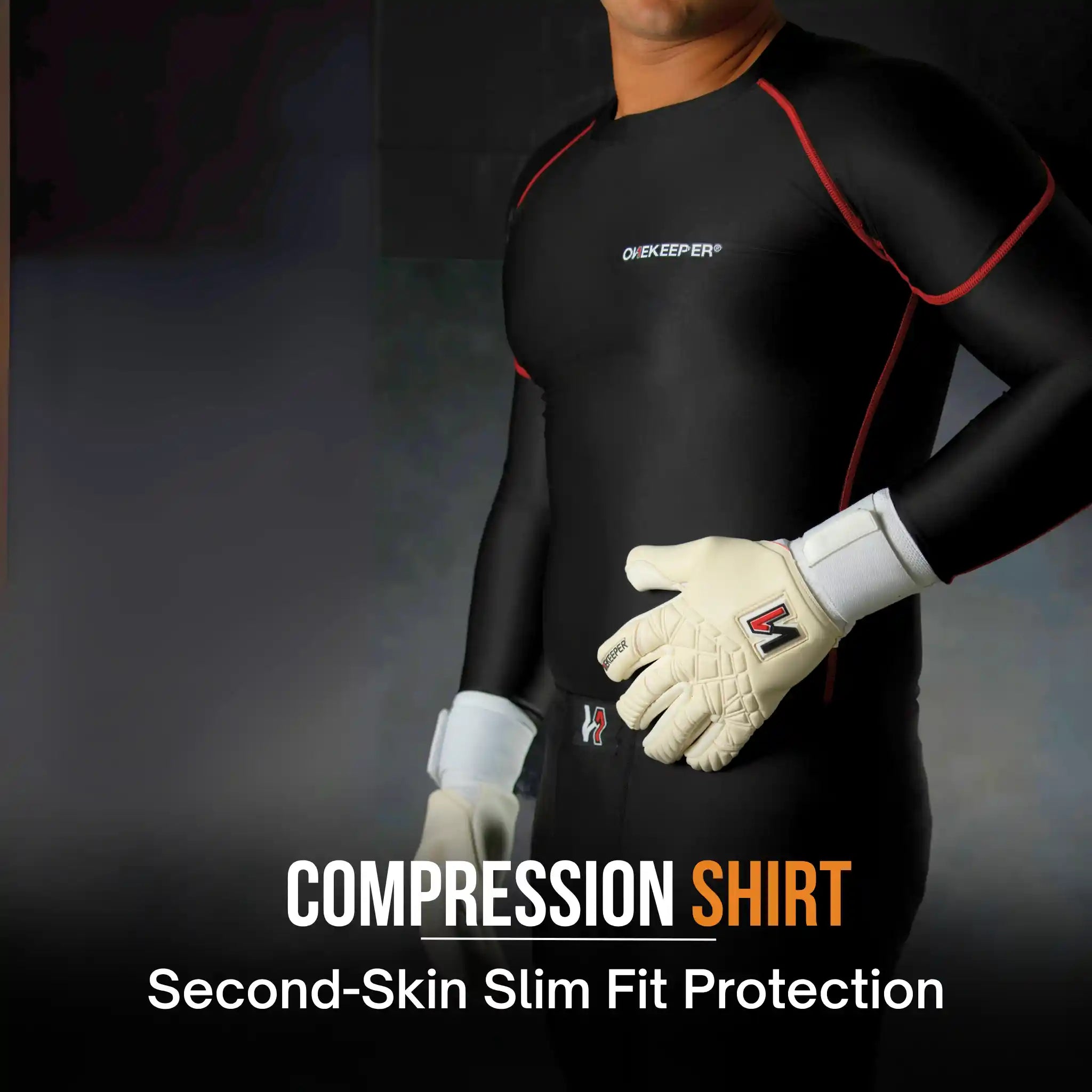 Person wearing a onekeeper black compression shirt with red accents, holding gloves, on a dark background.