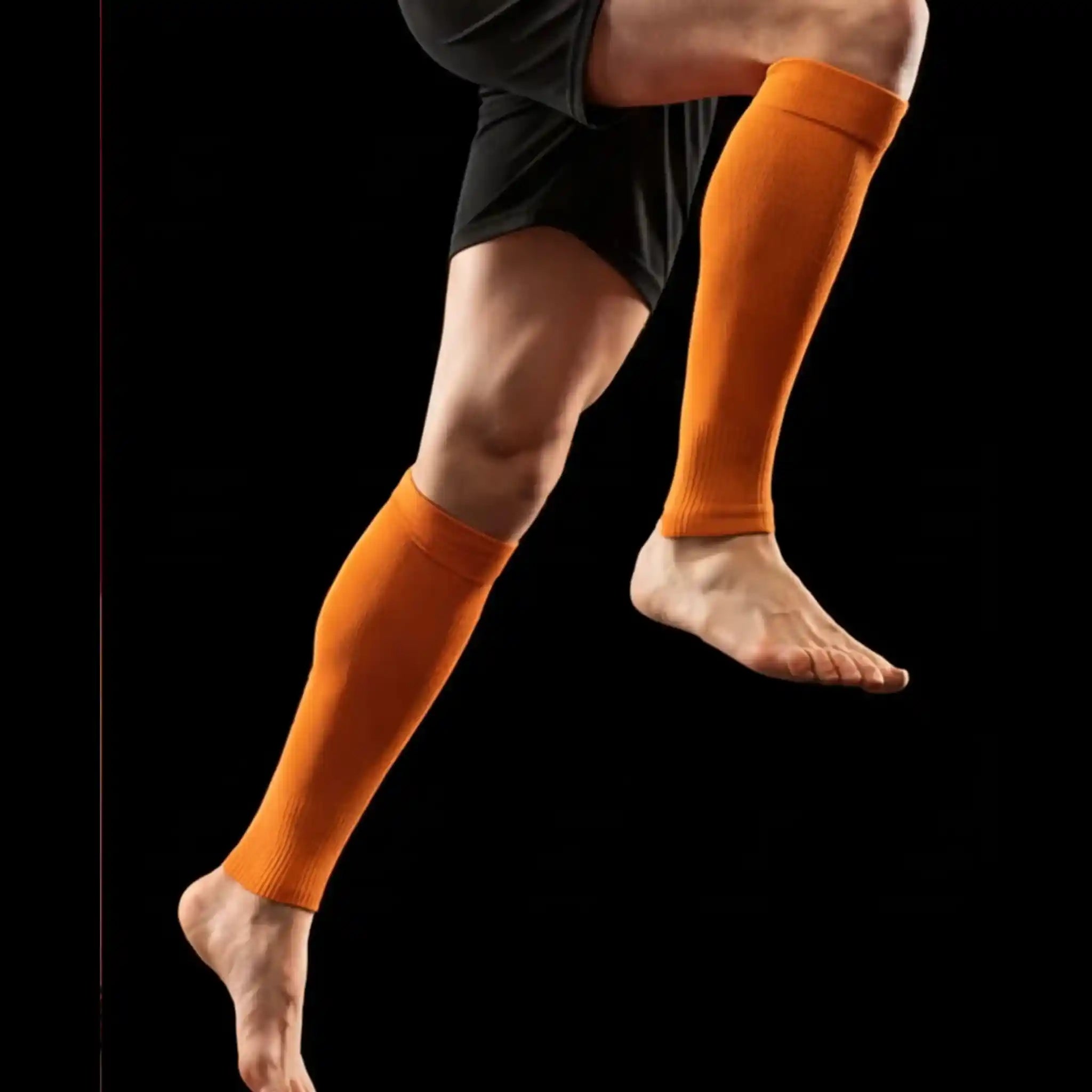 Person wearing onekeeper orange calf sleeve on a black background