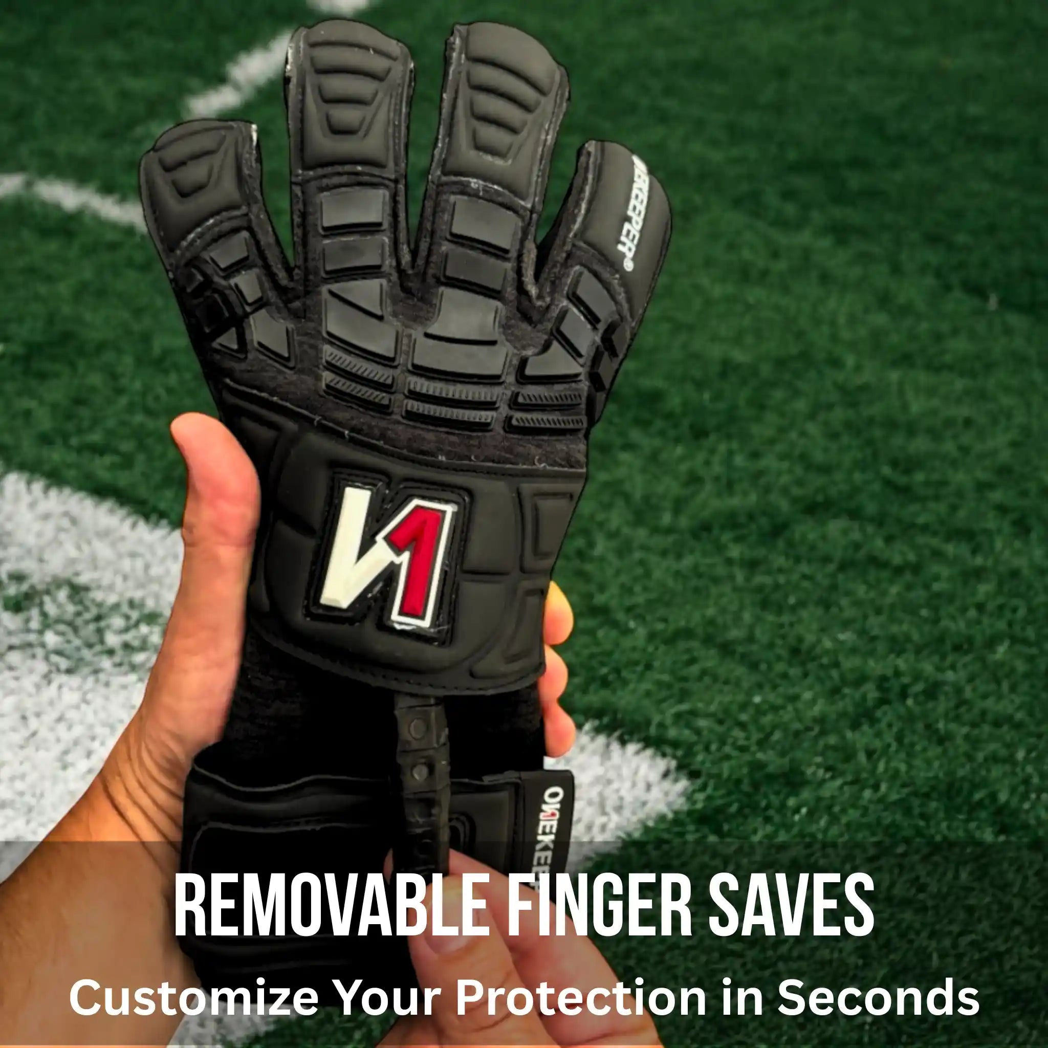 ONEKEEPER Solid Black glove with removable finger saves held in a hand on a sports field background