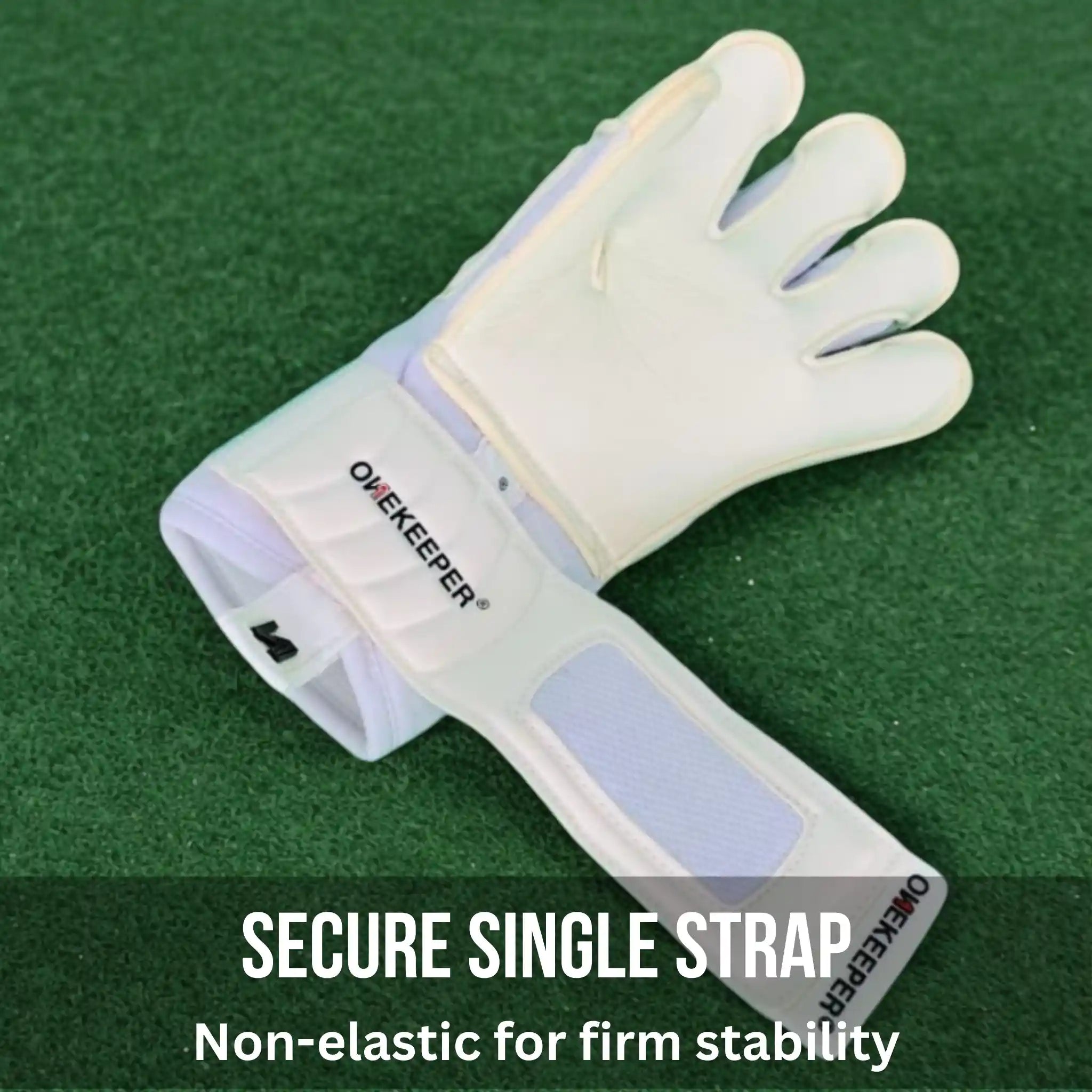 ONEKEEPER Solid White goalkeeper glove with a secure single strap on a green background