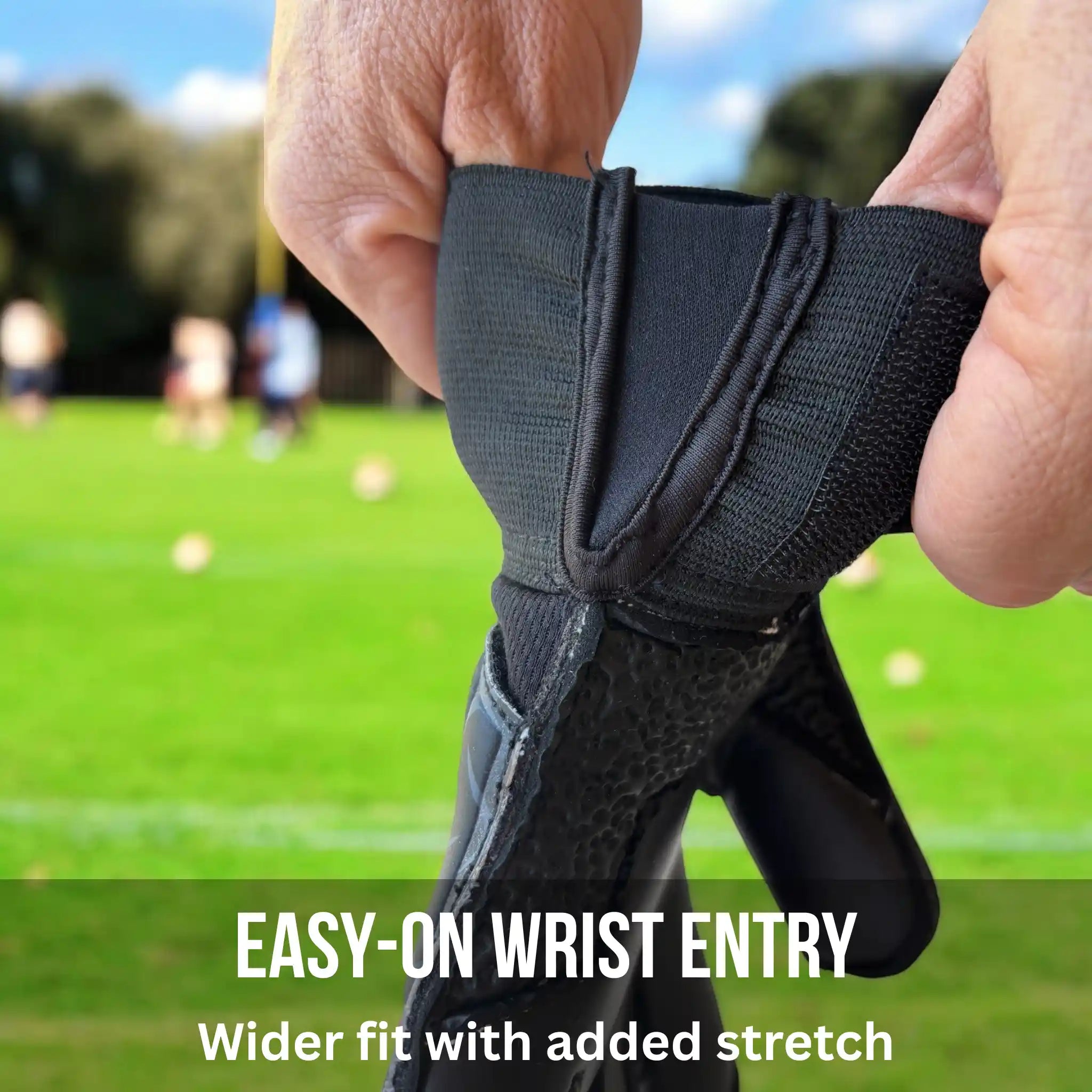 Vector Evolution Black and Pink wrist support with 'Easy-On Wrist Entry' text on a blurred sports field background