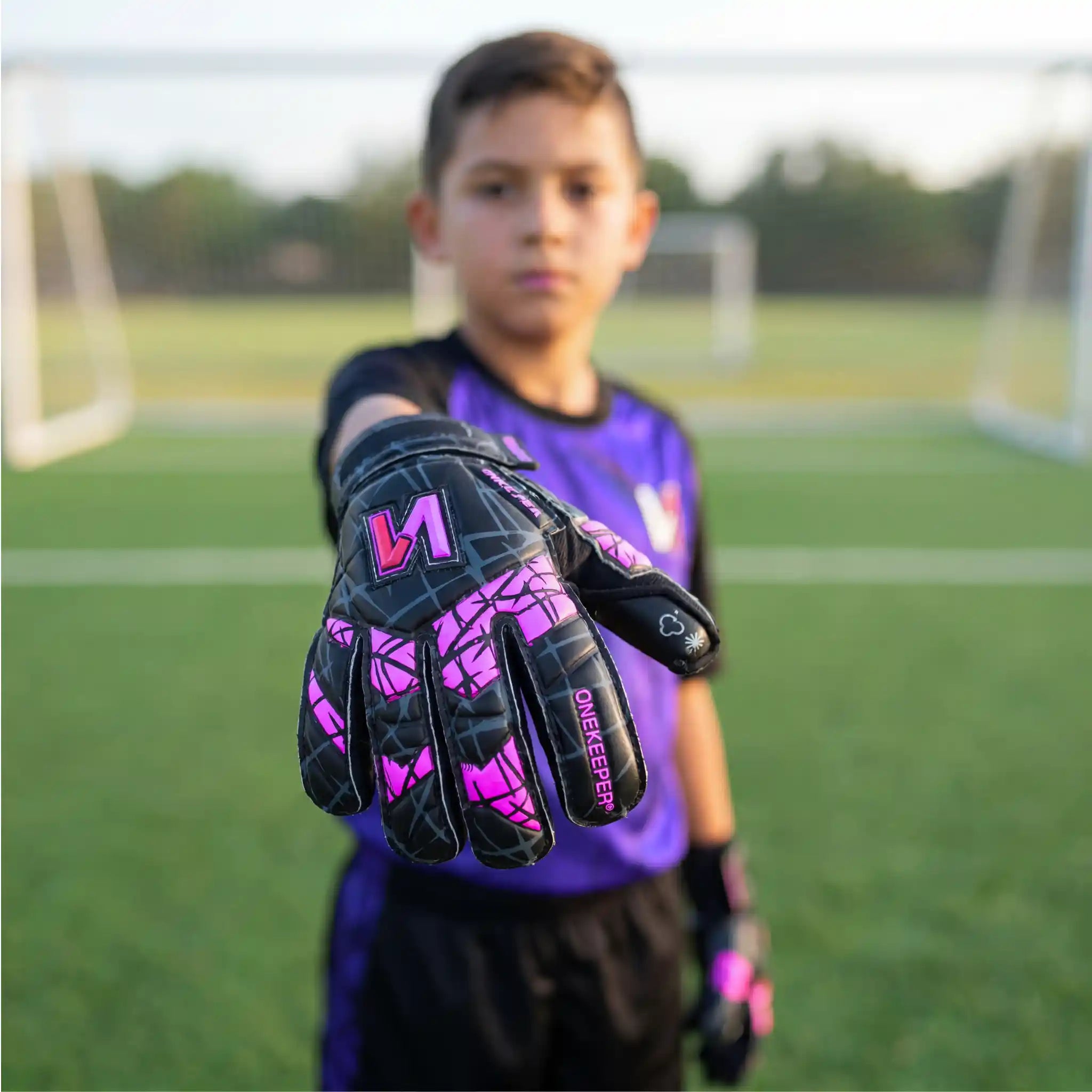 Kid showing his ONEKEEPER Vector Evolution Black and Purple
