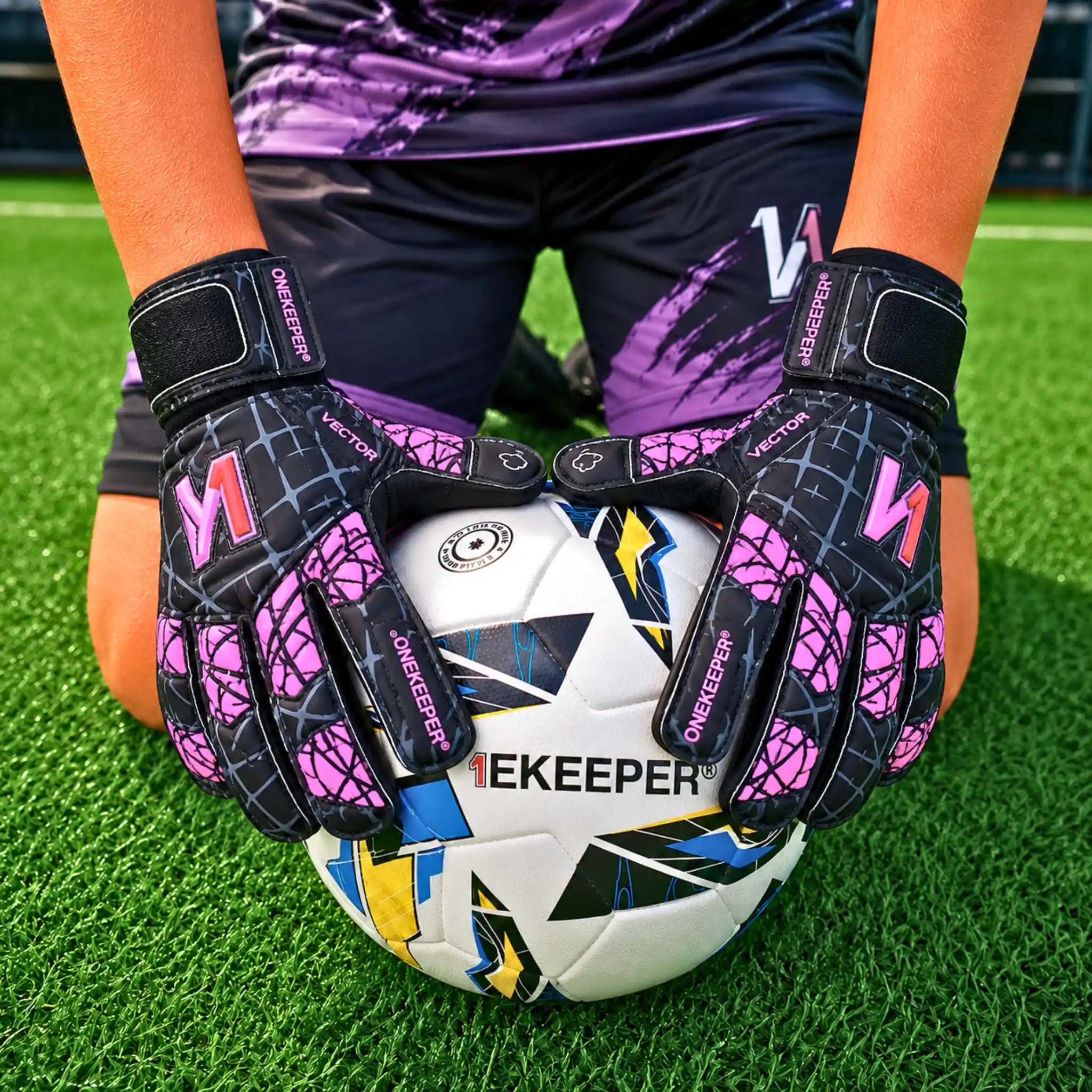 Kid holding a bal wearing a ONEKEEPER Vector Evolution black and purple.