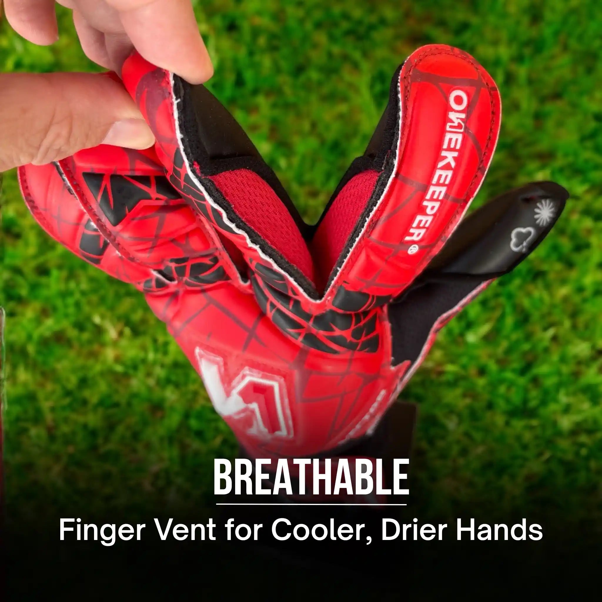 ONEKEEPER Vector Evolution Red goalkeeper glove with breathable feature on grass background
