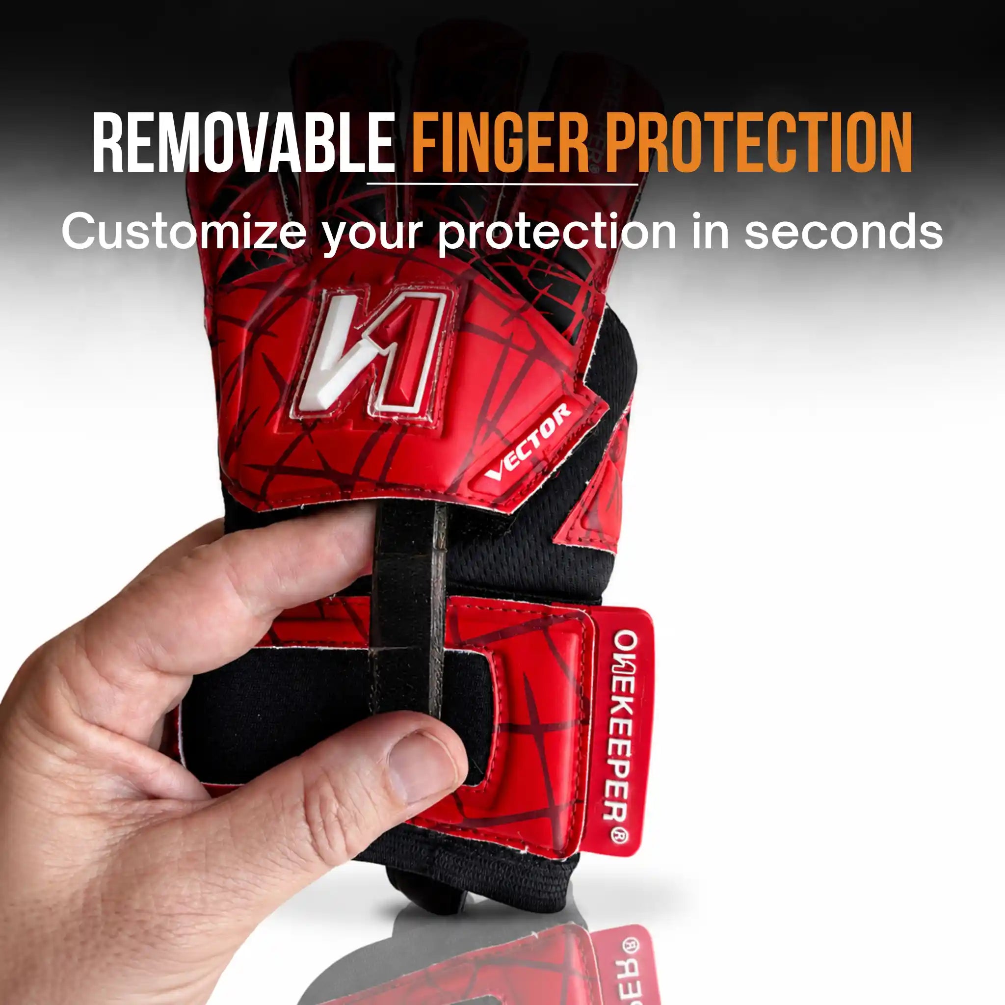 ONEKEEPER Vector Evolution Red and black protective glove with removable finger protection held by a hand, against a neutral background.