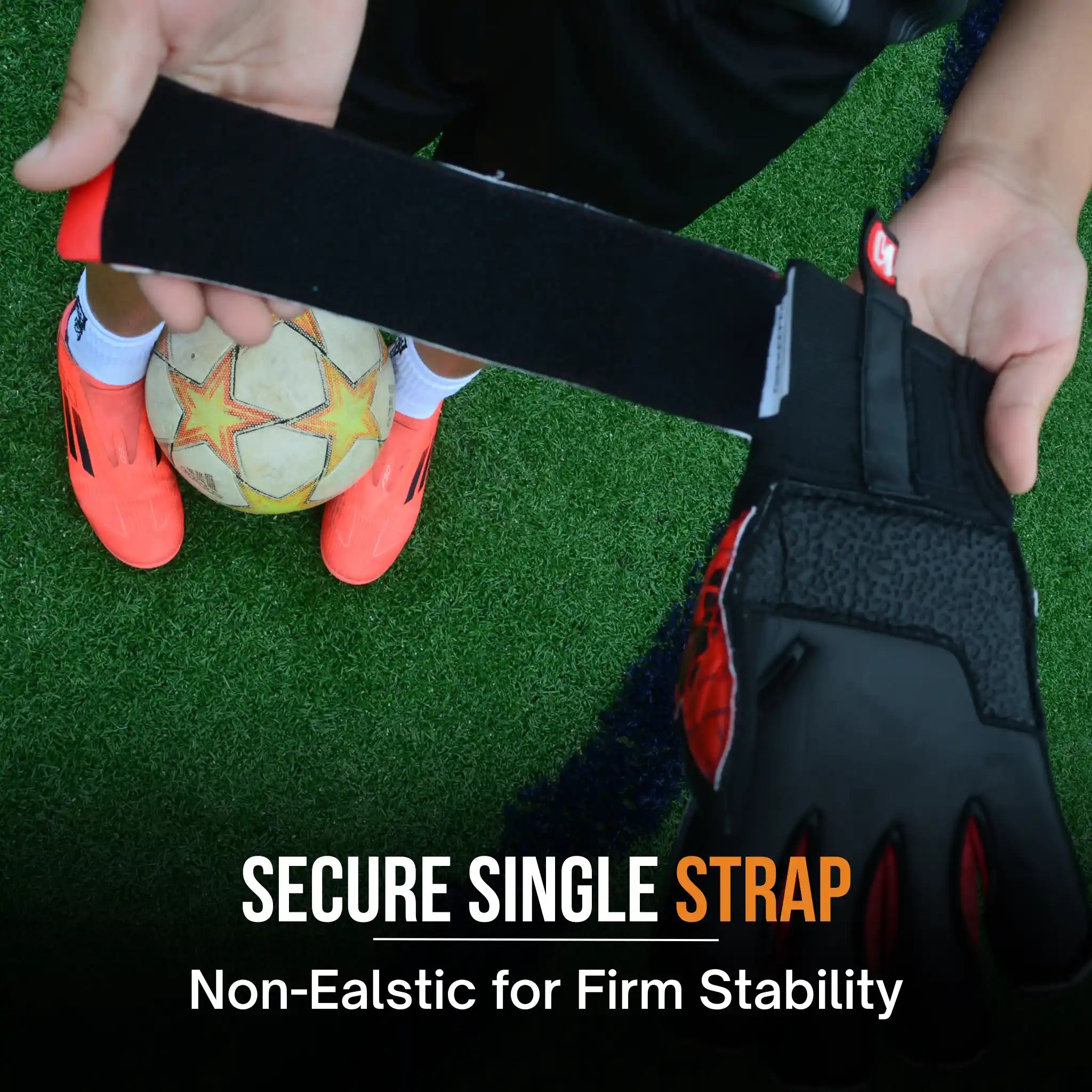 Person holding a ONEKEEPER Vector Evolution Red gloves with a black strap and glove on grass