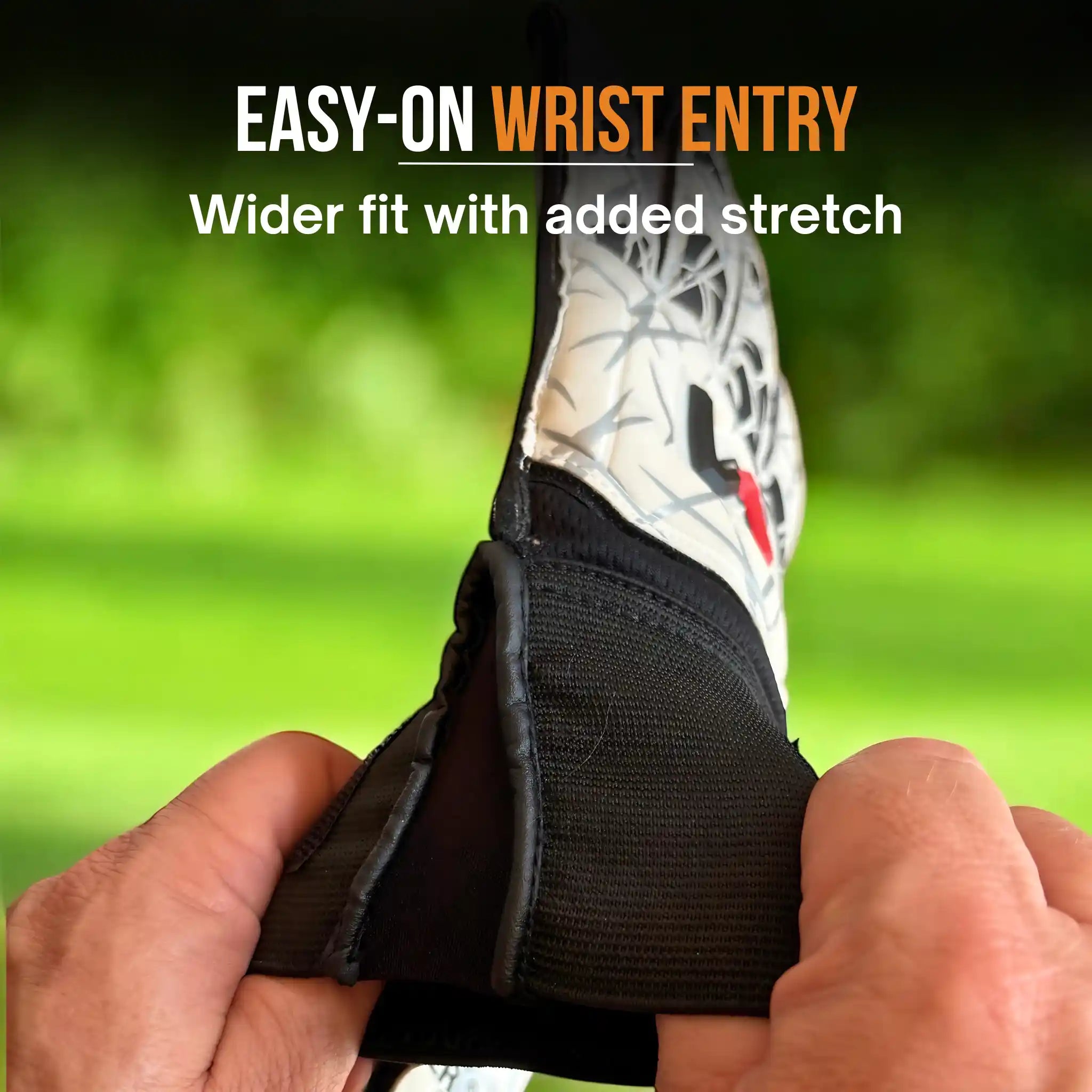 Person adjusting a onekeeper vector evolution white and black wrist entry shoe with text on a green background