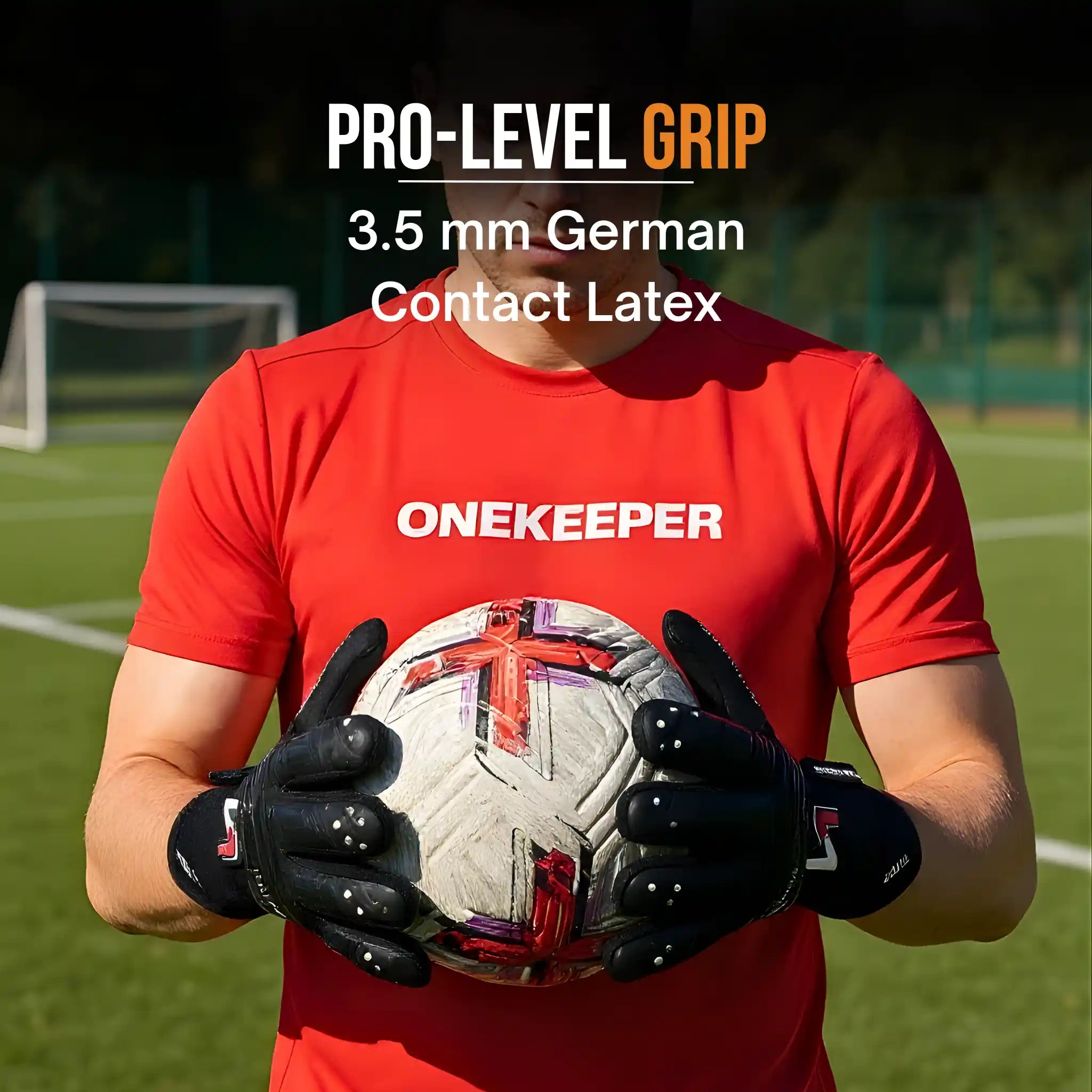 Person wearing a red 'ONEKEEPER' shirt holding a soccer ball on a sports field with a onekeeper viper black glove.