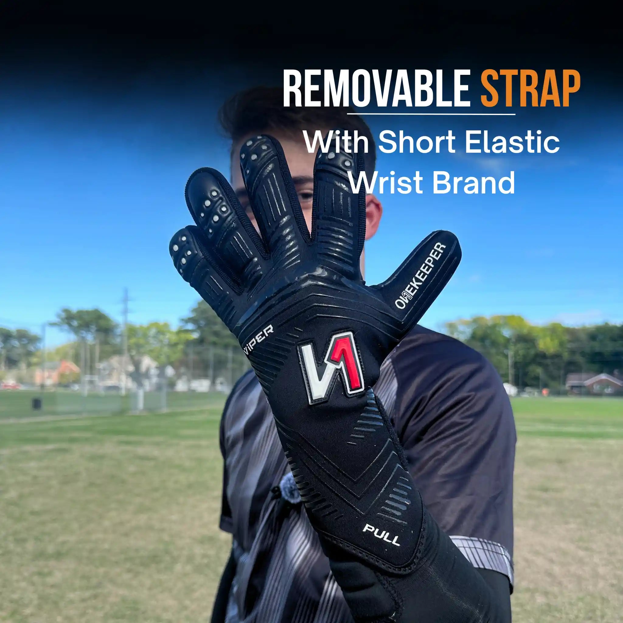 Person wearing a onekeeper viper black glove with a visible brand logo on a sports field.