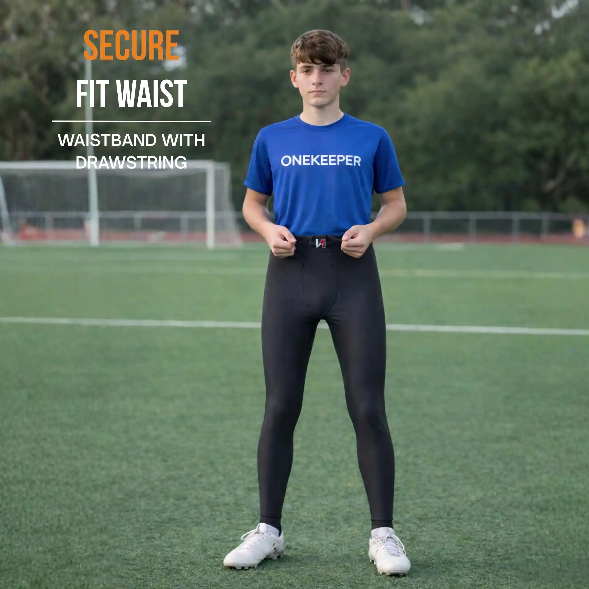 Person wearing ONEKEEPER black leggings with a waistband, standing on a sports field, promoting 'OneKeeper' brand.