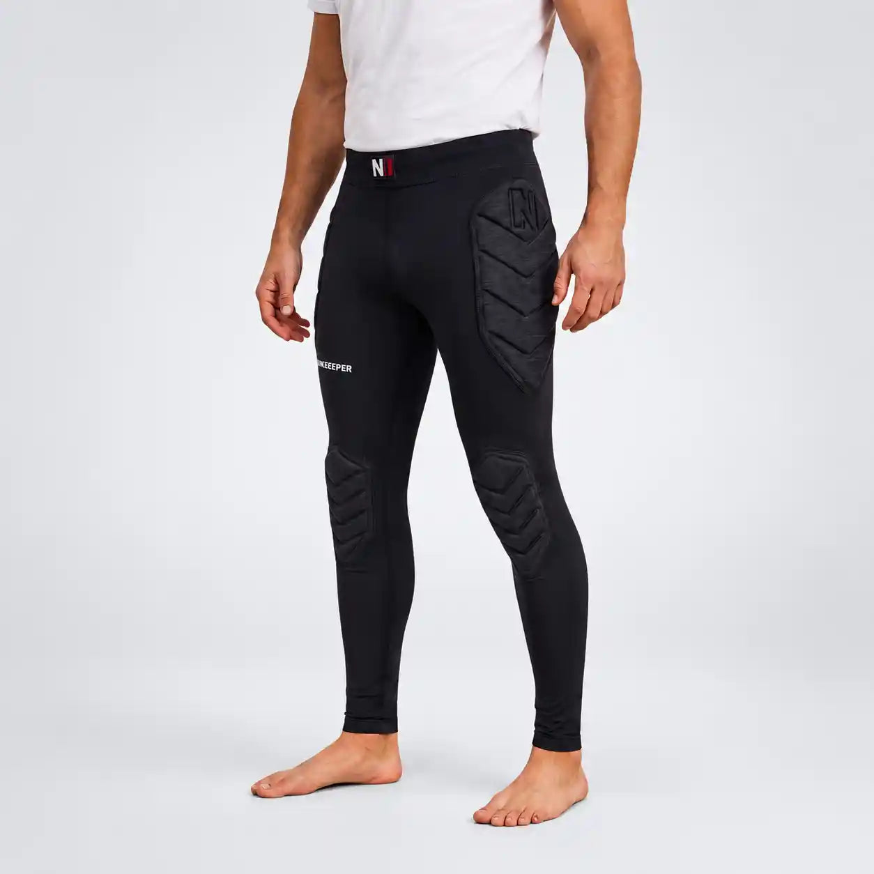 Black full-length onekeeper padded leggings knee and hip pads , shown on a model from the waist down against a light gray studio background.