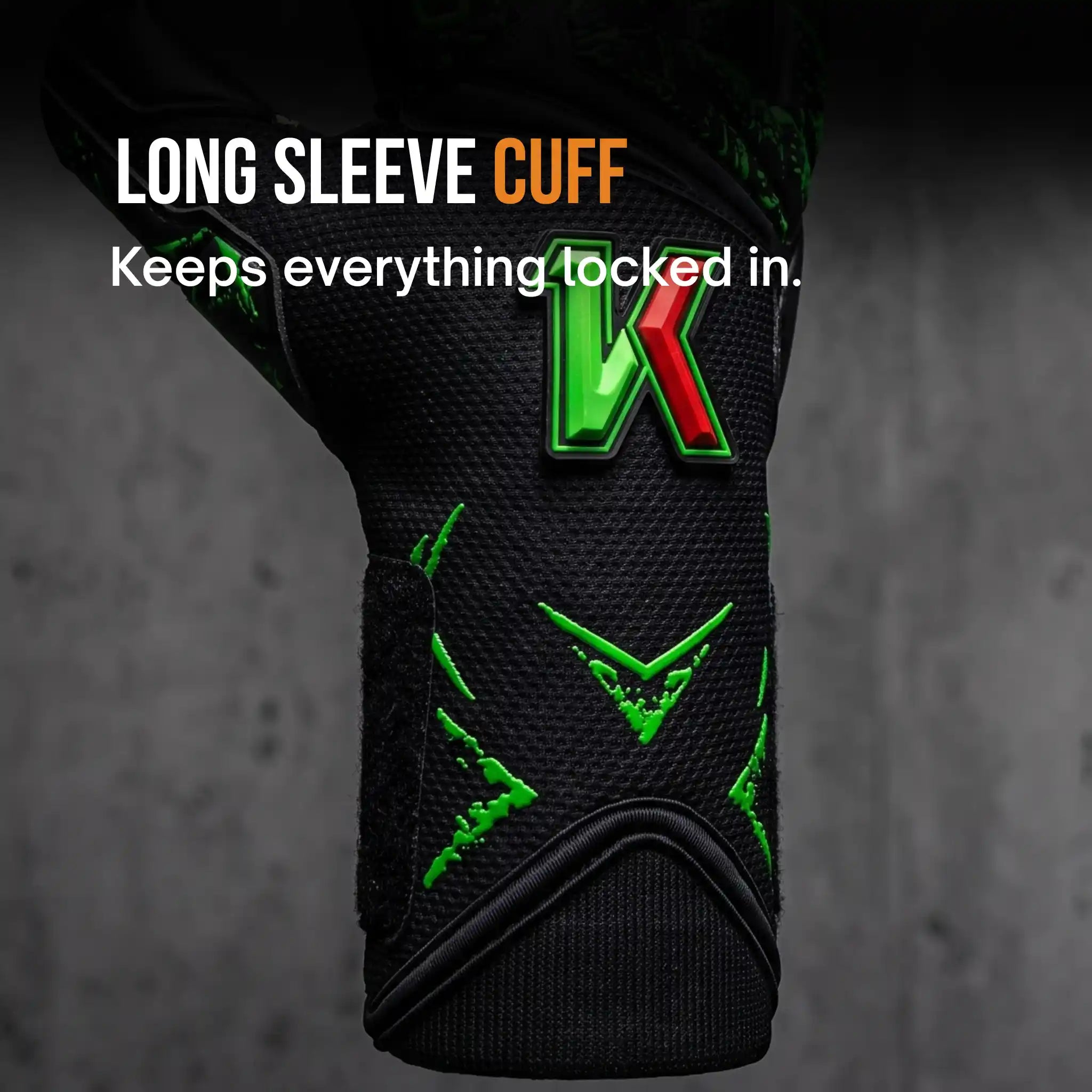 Close-up of a onekeeper legacy black long sleeve athletic cuff with bright green and red logo accents, shown against a dark gray textured background with the text 'LONG SLEEVE CUFF Keeps everything locked in.'.