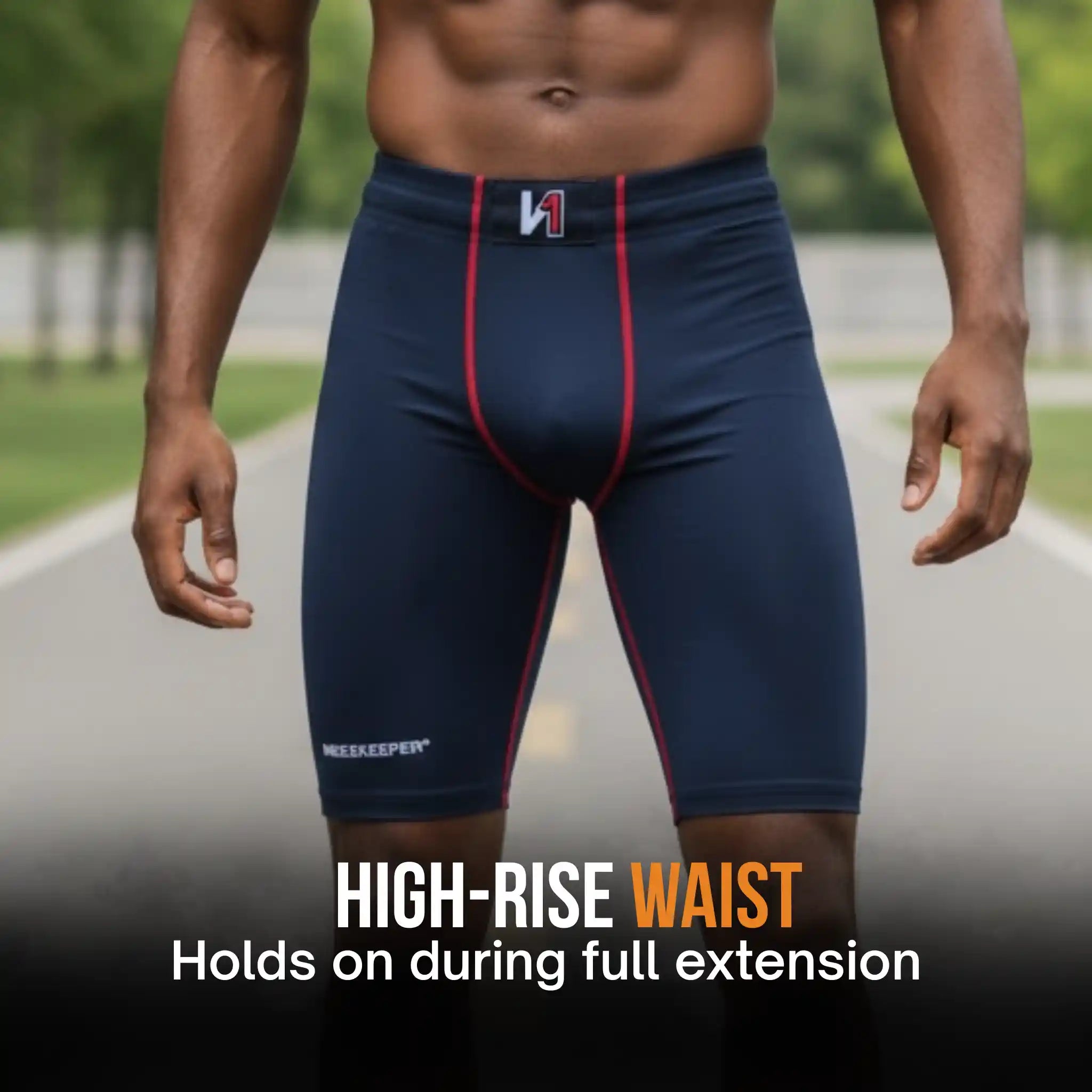 A cropped male model wearing navy high-rise onekeeper compression shorts with red side piping and a small white logo at the front waistband, standing on an outdoor path. Text at the bottom reads 'HIGH-RISE WAIST Holds on during full extension.